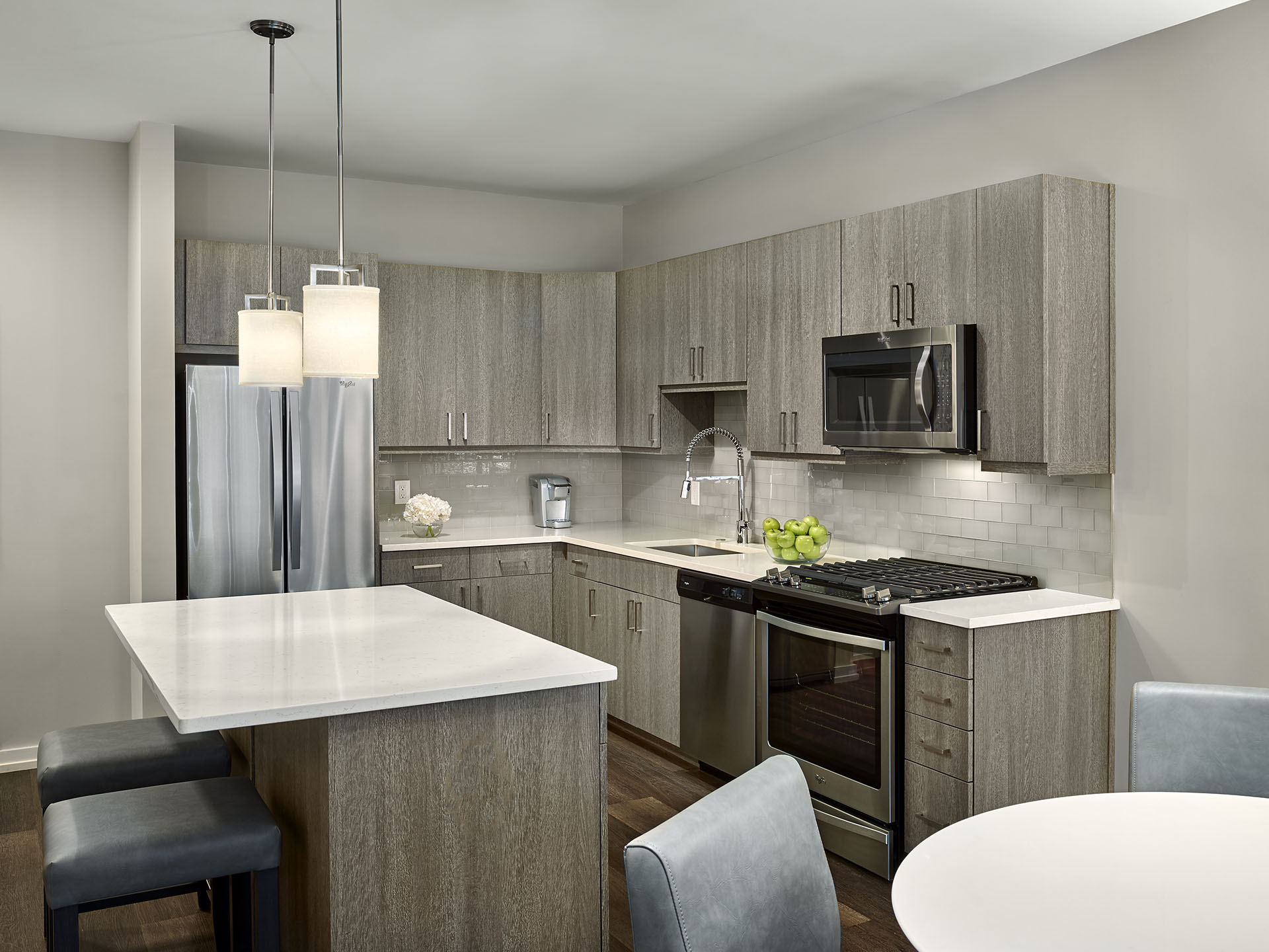 Modern kitchen with an island and bar stools in King of Prussia furnished apartment