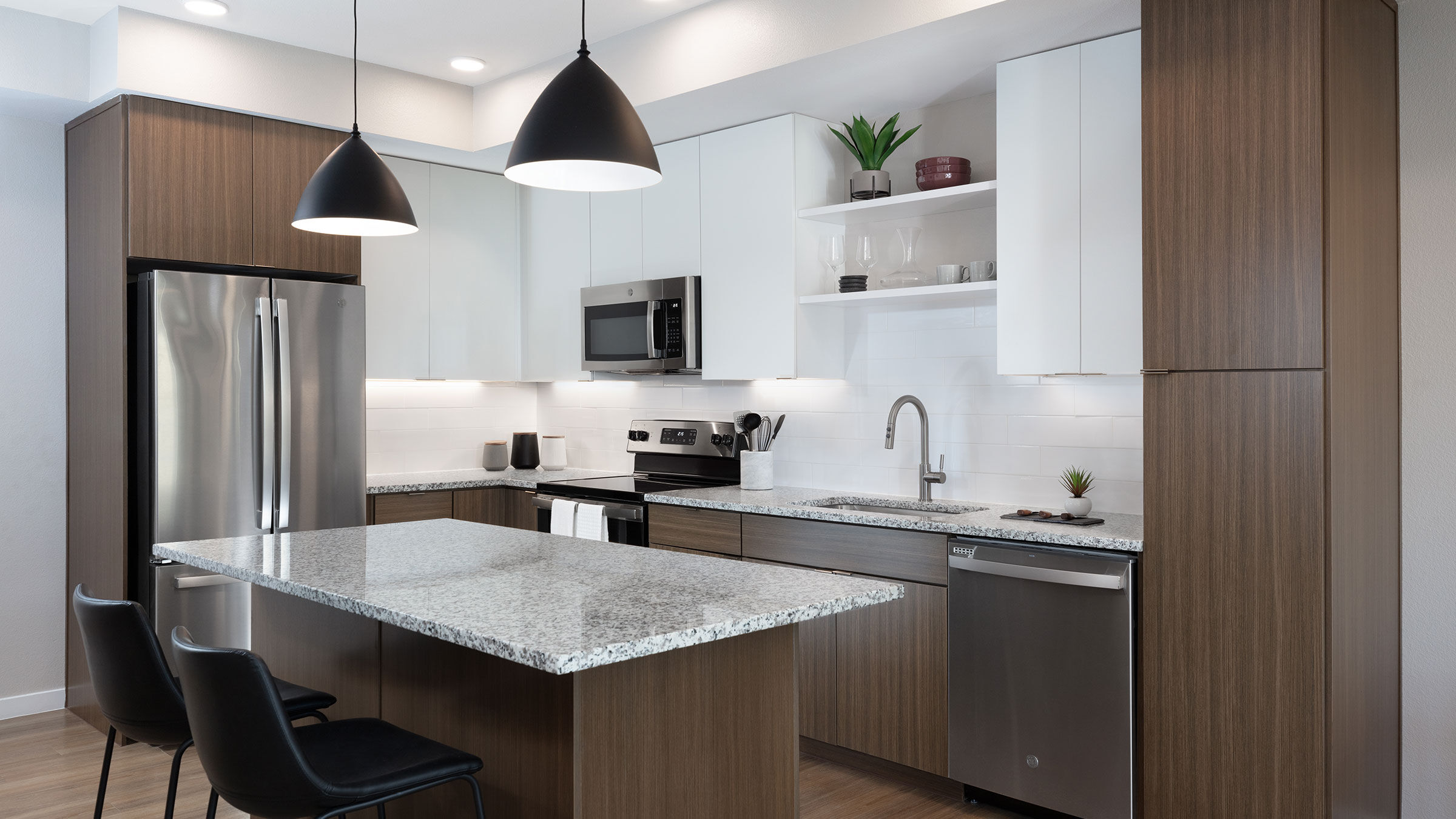 a kitchen with white cabinets and black chairs