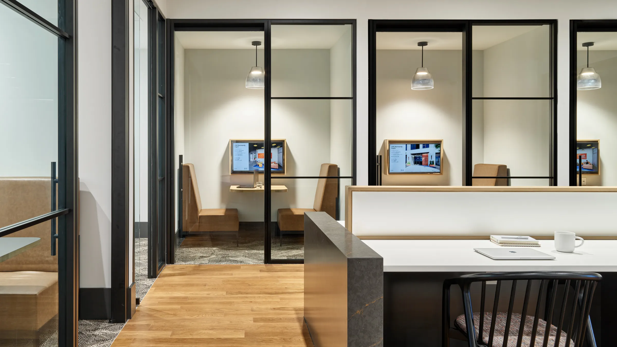 a room with glass walls and a desk