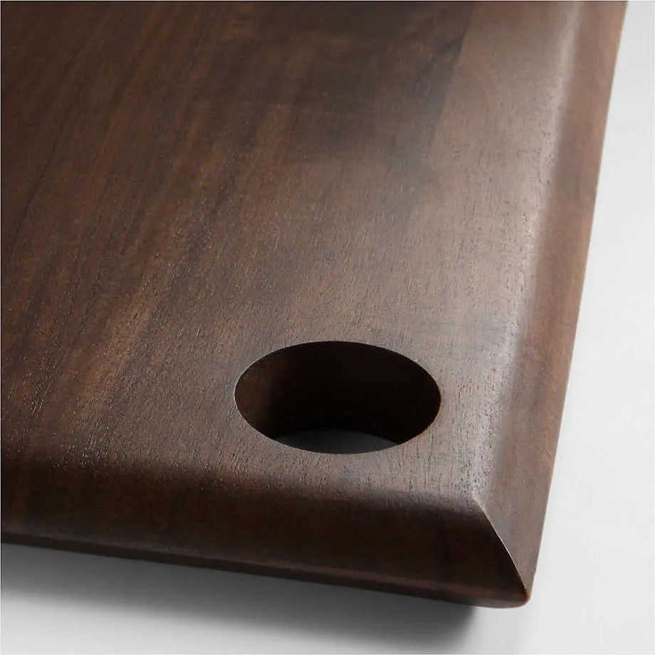 a wooden cutting board with a hole