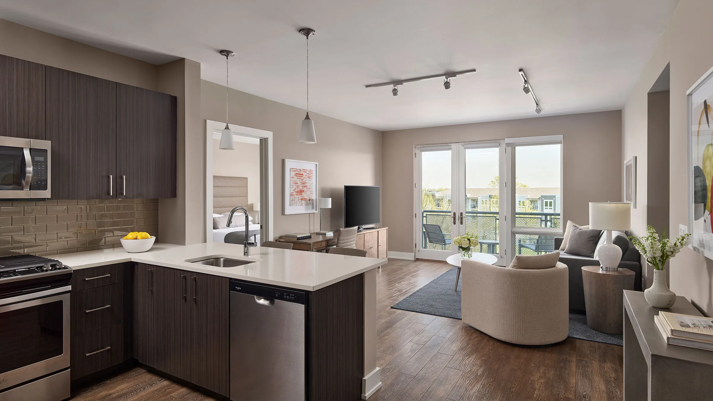 a living room with a kitchen and a television