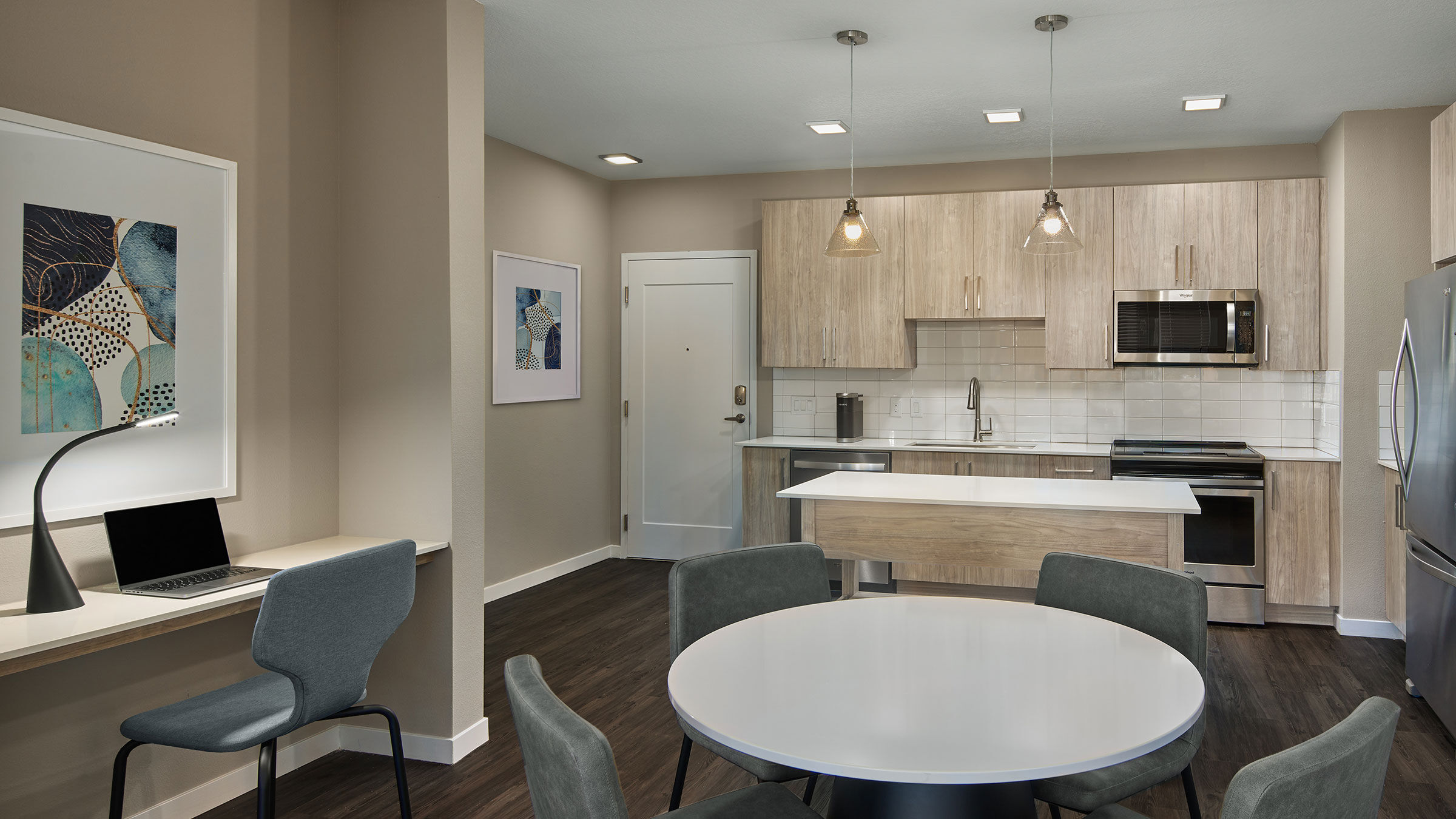 a kitchen with a white table and chairs