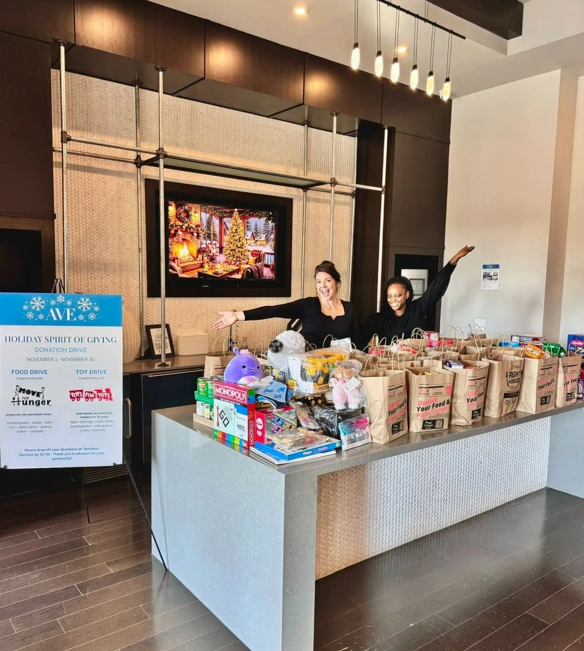 Women smiling with a table full of donations
