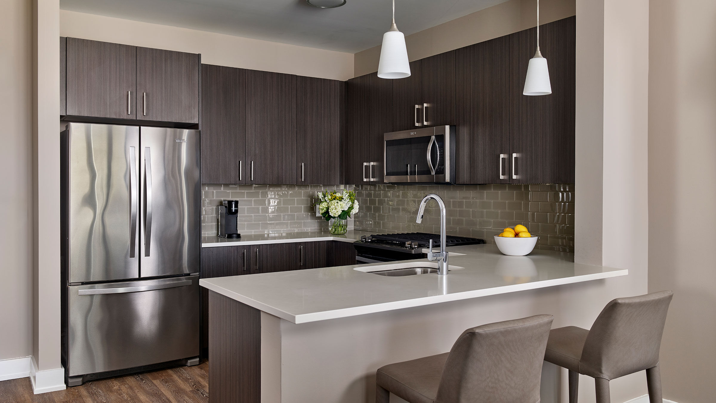 a kitchen with a stainless steel refrigerator and a sink