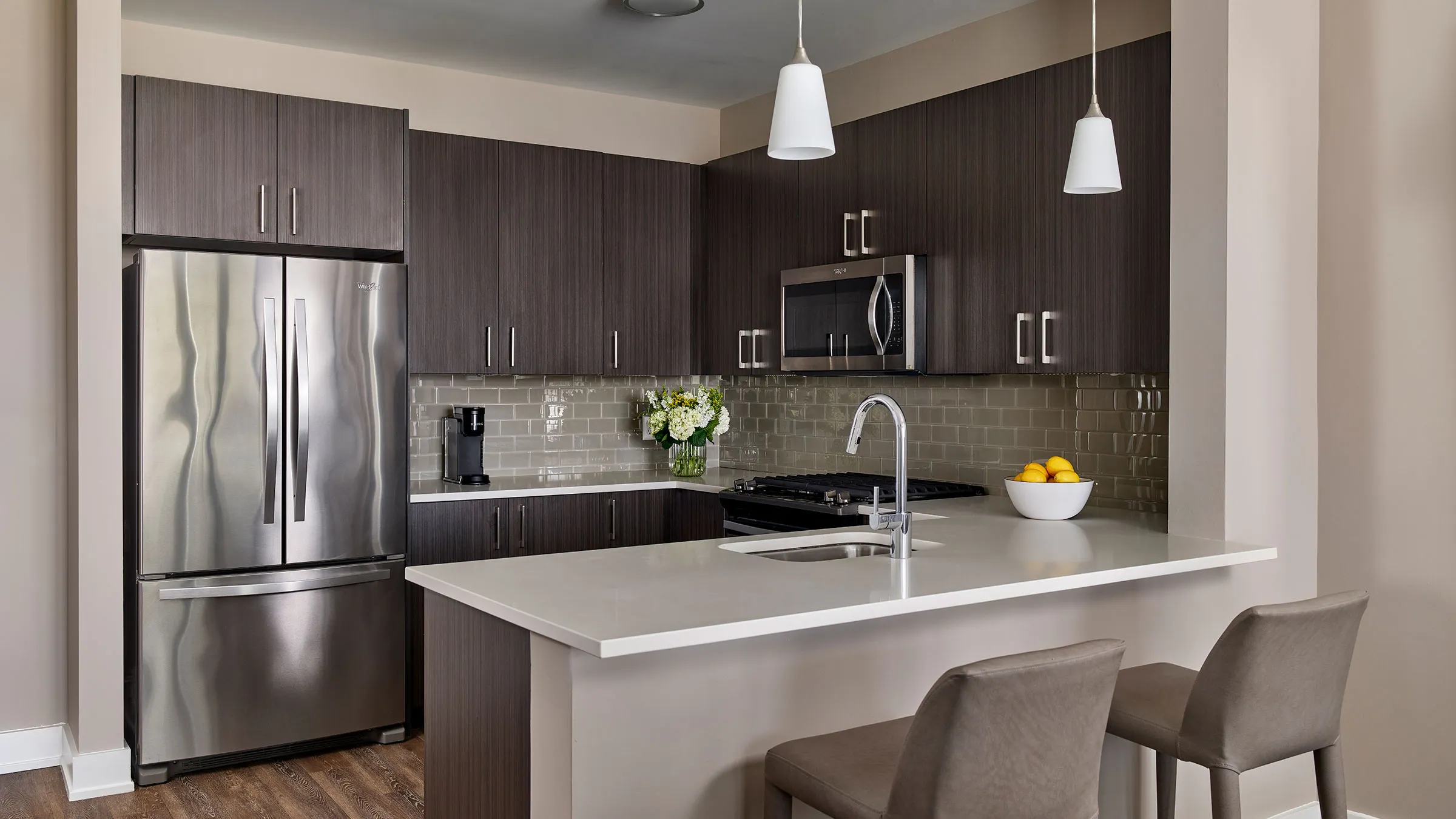 a kitchen with a stainless steel refrigerator and a sink