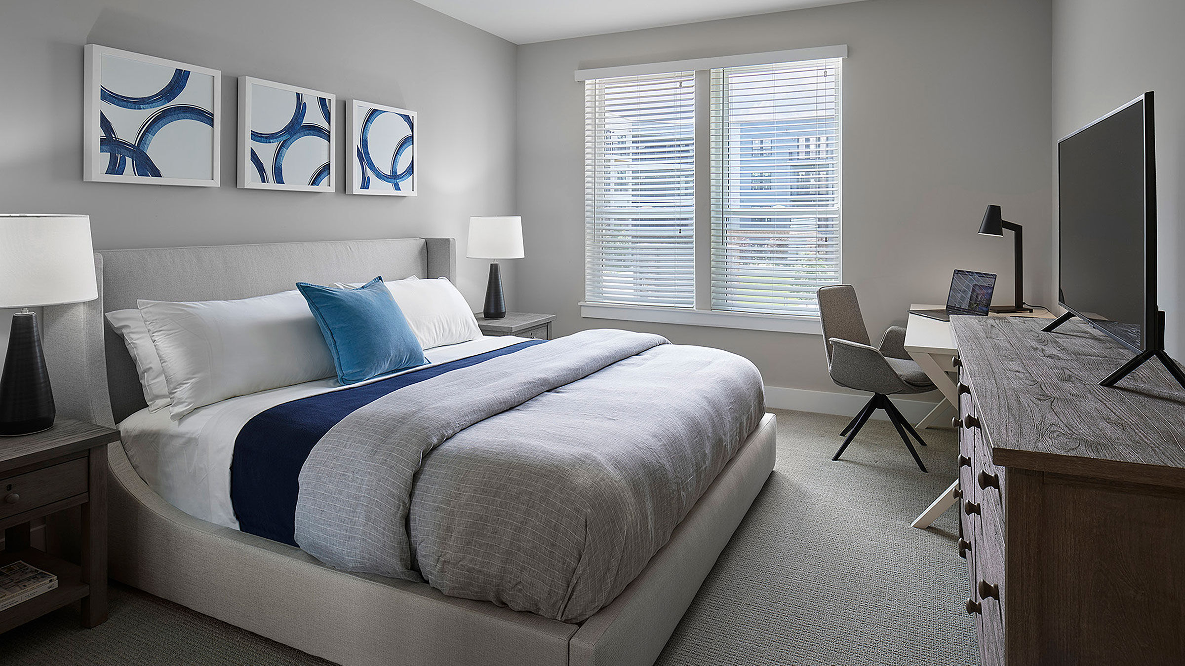 a bedroom with a bed and a desk