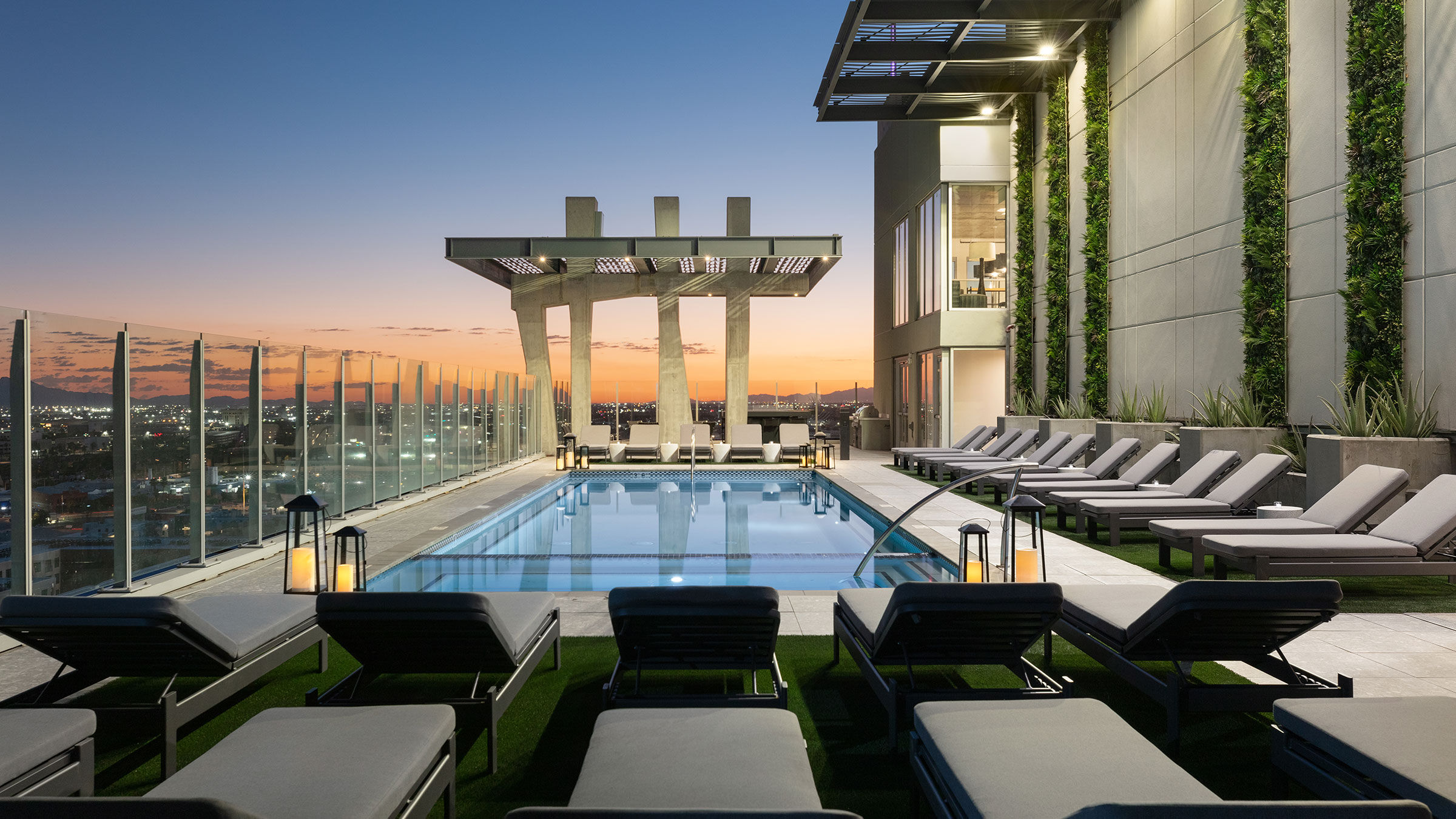 a pool with lounge chairs and a roof top