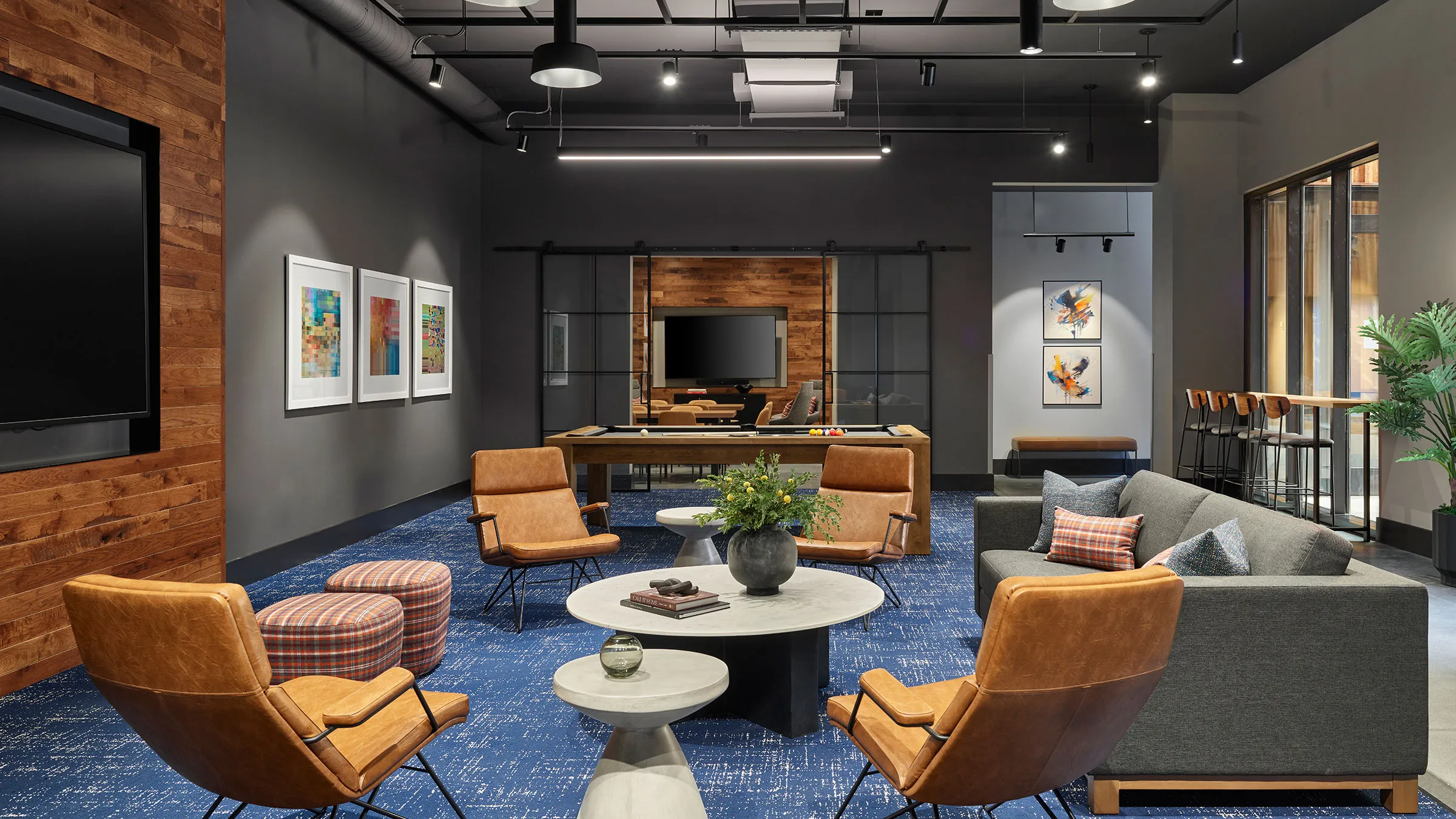 a room with a pool table and chairs