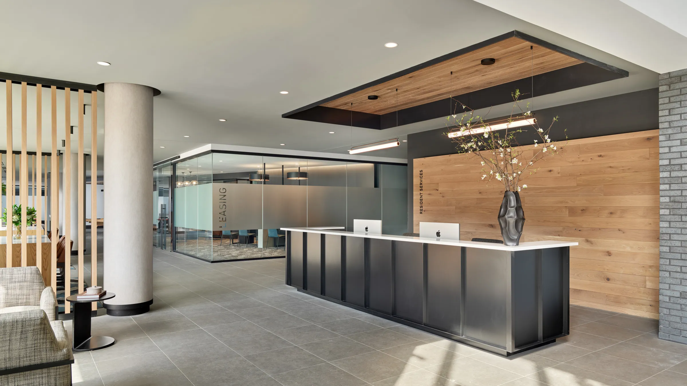a lobby with a reception desk and glass walls