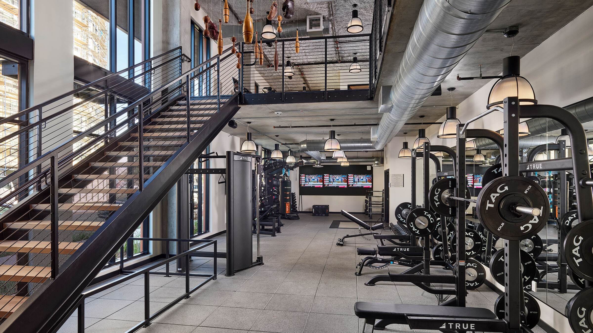 a gym with stairs and equipment