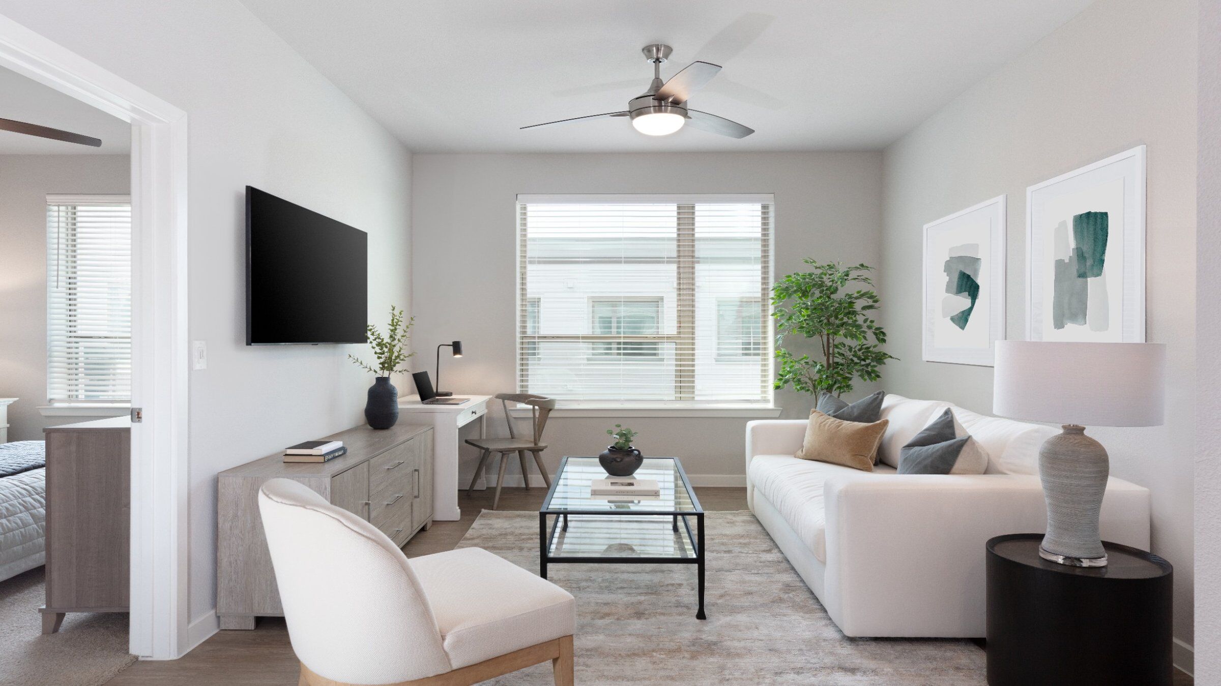 a living room with a white couch and a glass coffee table