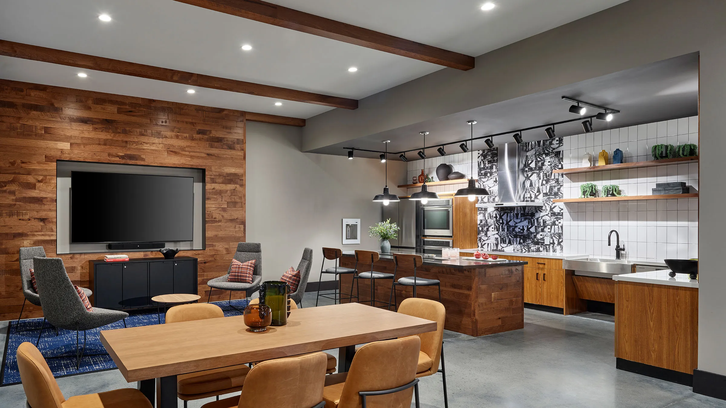 a kitchen with a large island and blue stools