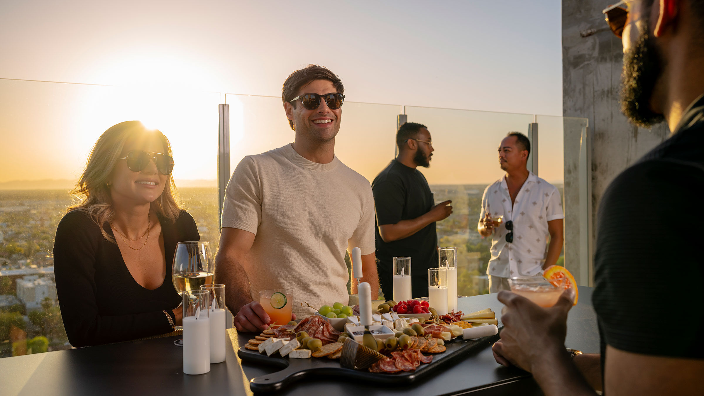 a group of people standing around a table with food on it
