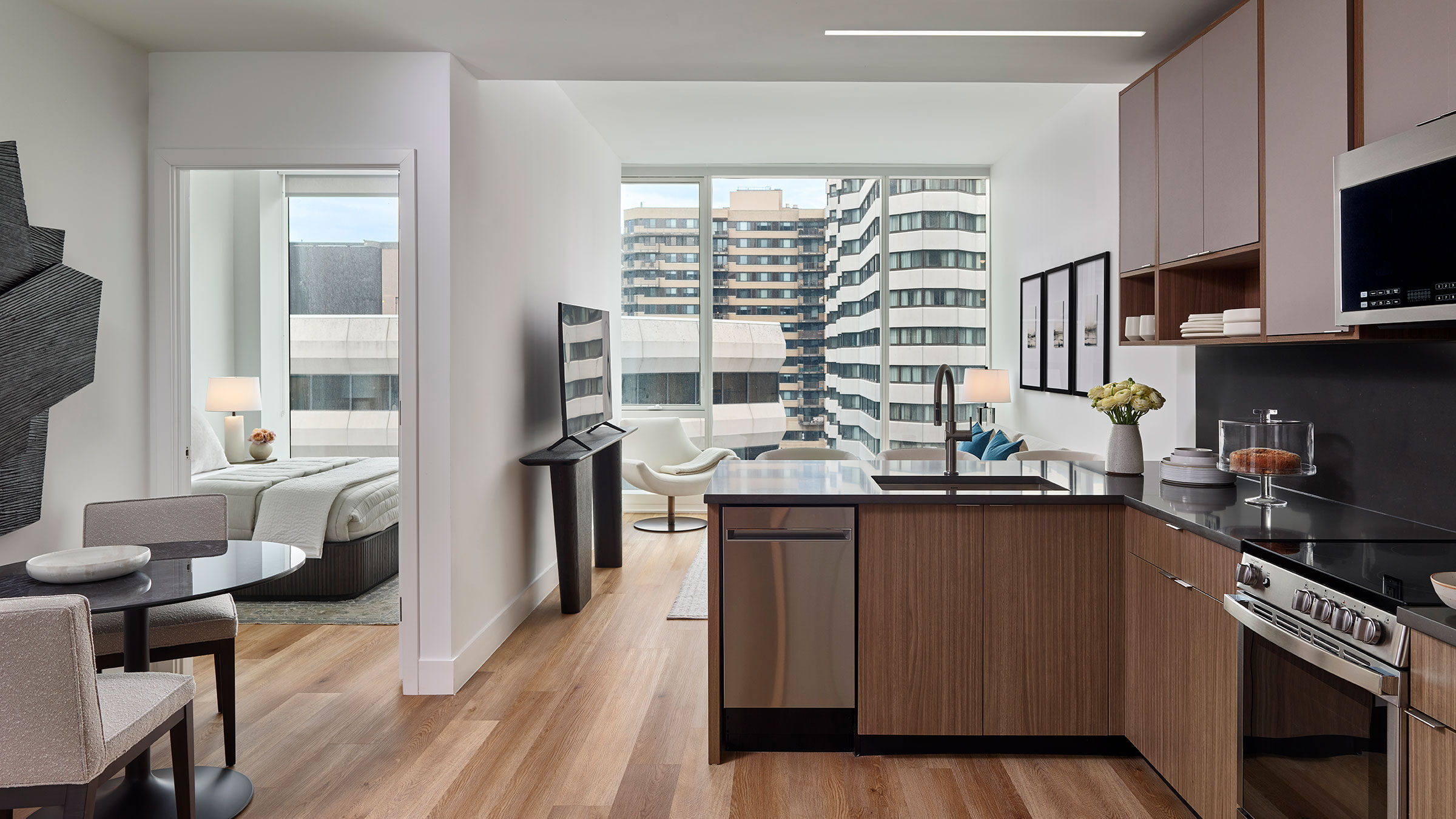 a room with a kitchen and a television