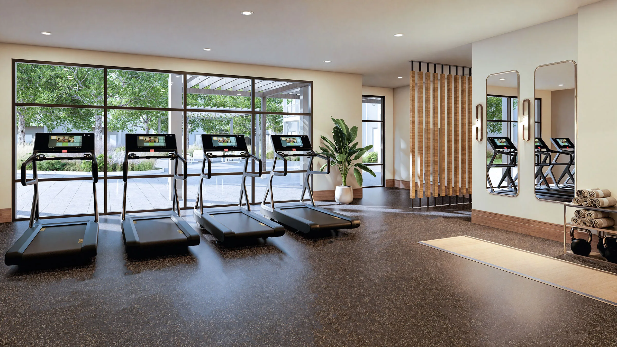 a room with treadmills and a plant