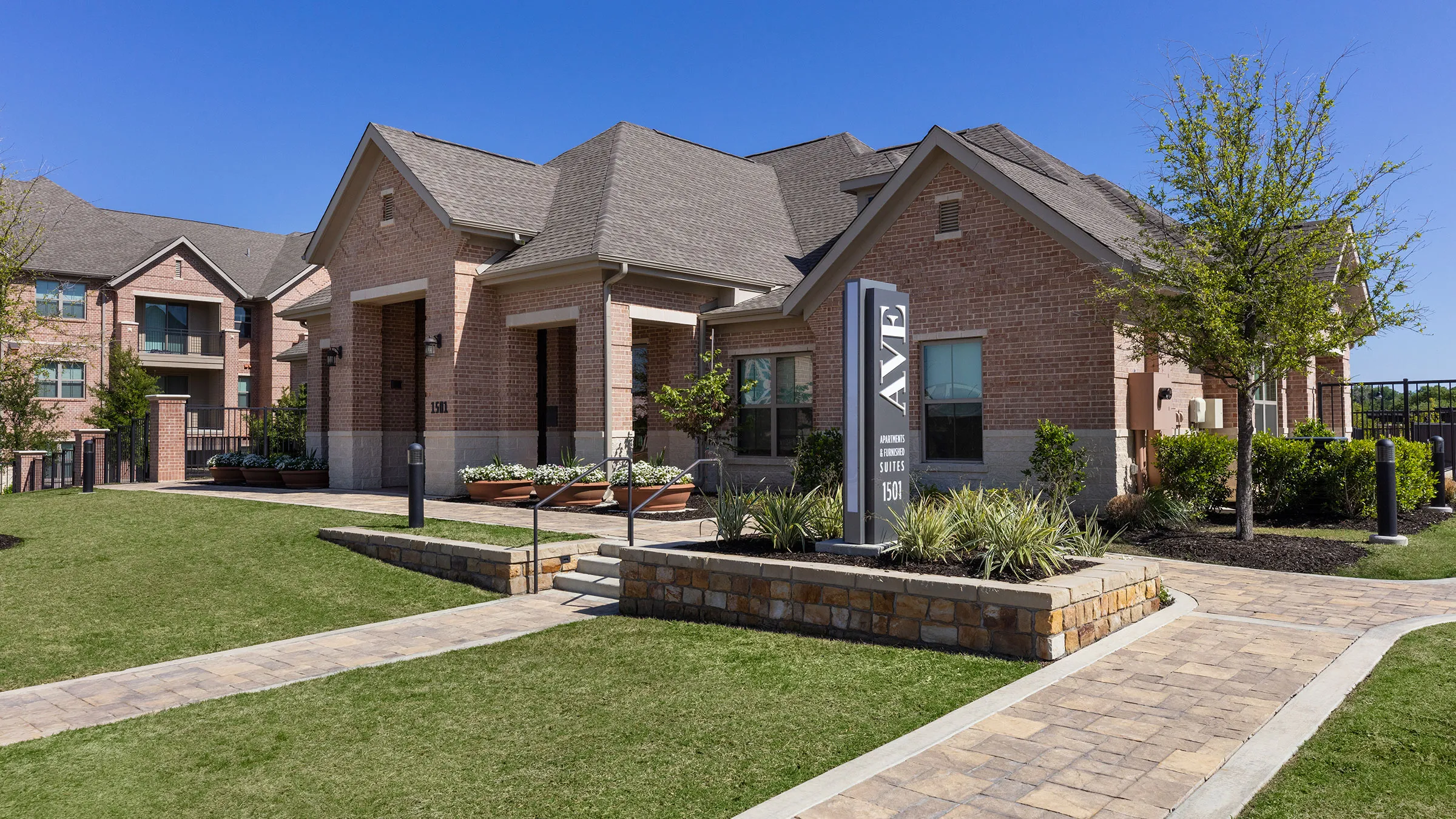 a brick house with a sign in front of it
