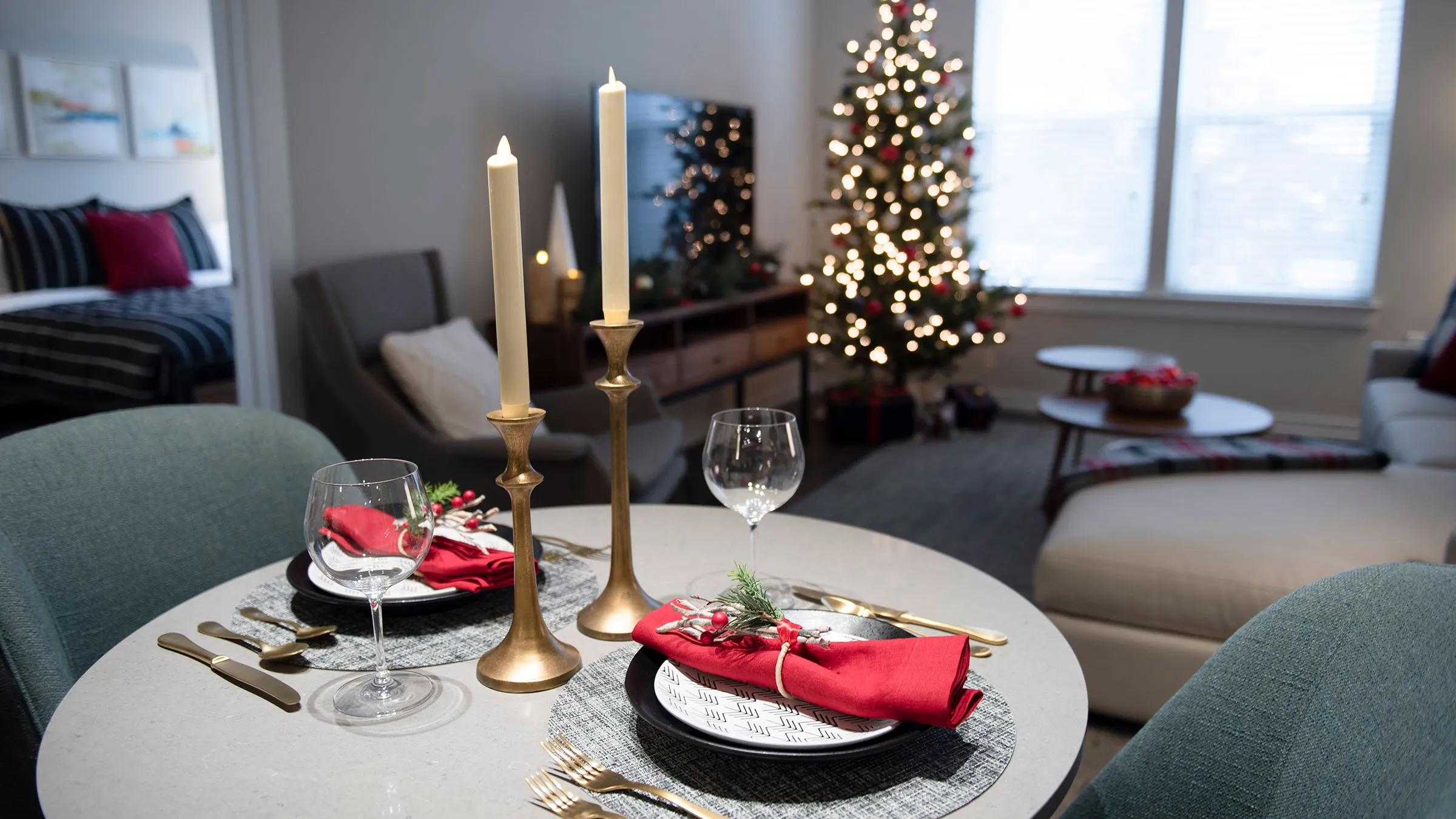 a table with a christmas tree and candles