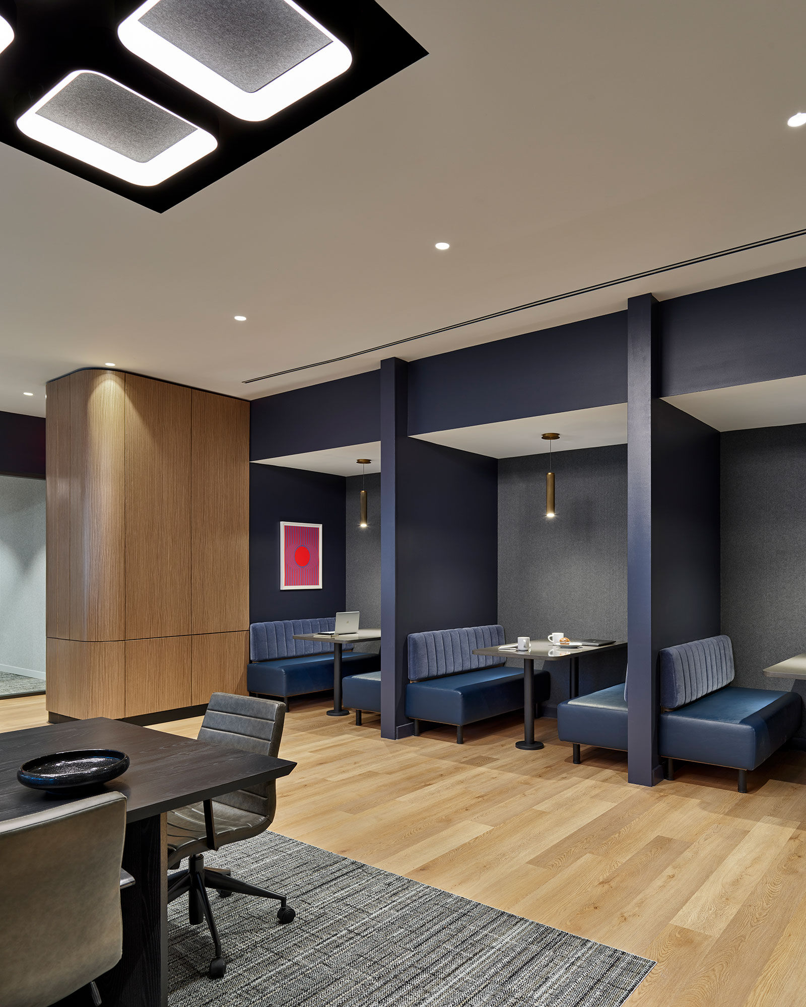 a room with blue couches and tables