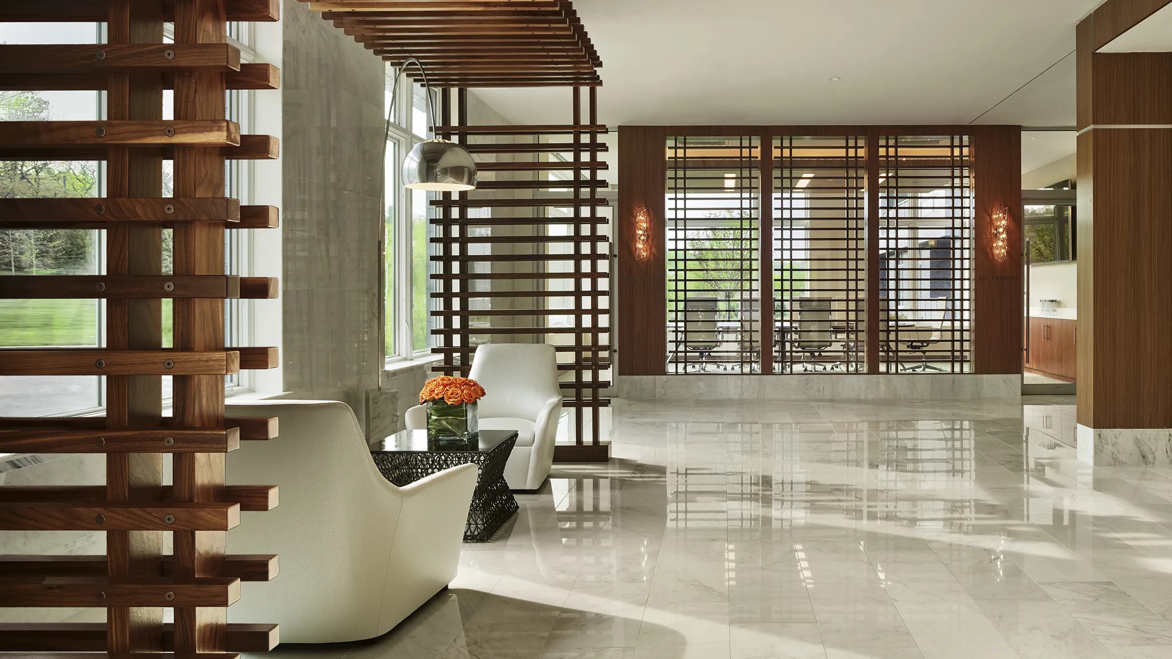 a room with white chairs and a table