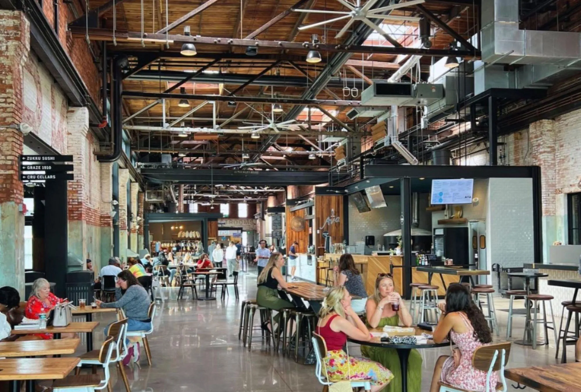 people sitting at tables in a large room at Armature Works in Tampa, FL