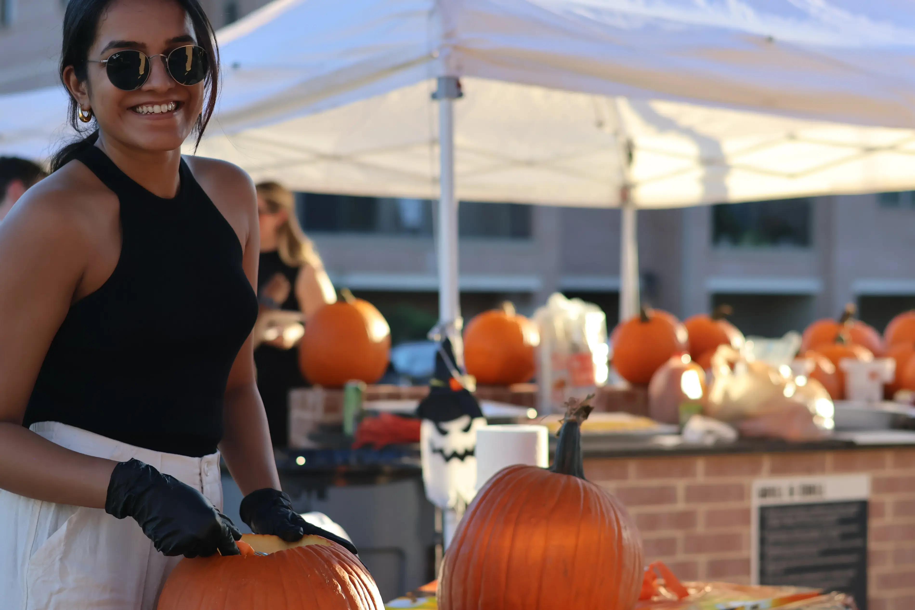 a woman holding a pumpkin