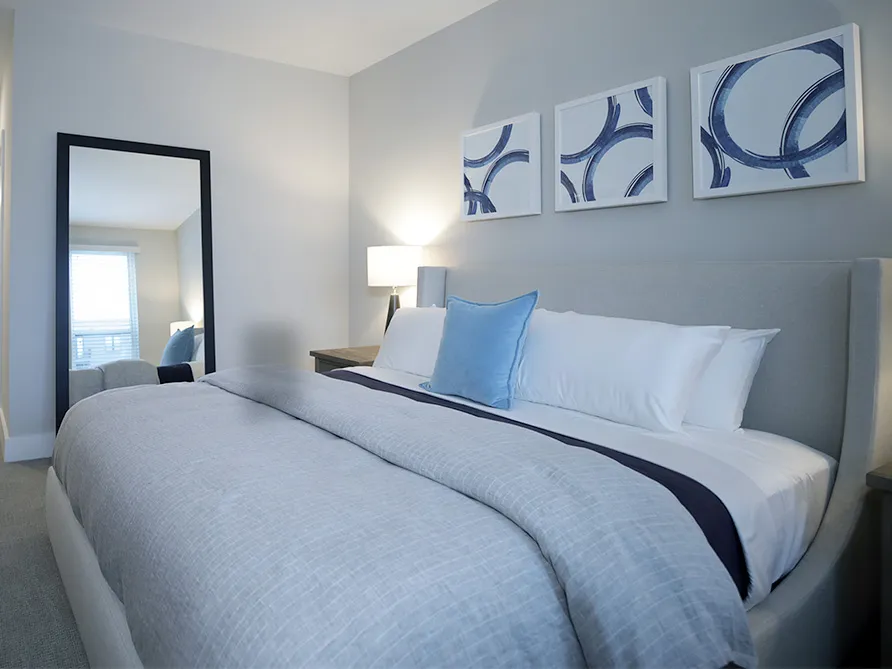 a bed with a mirror and a table