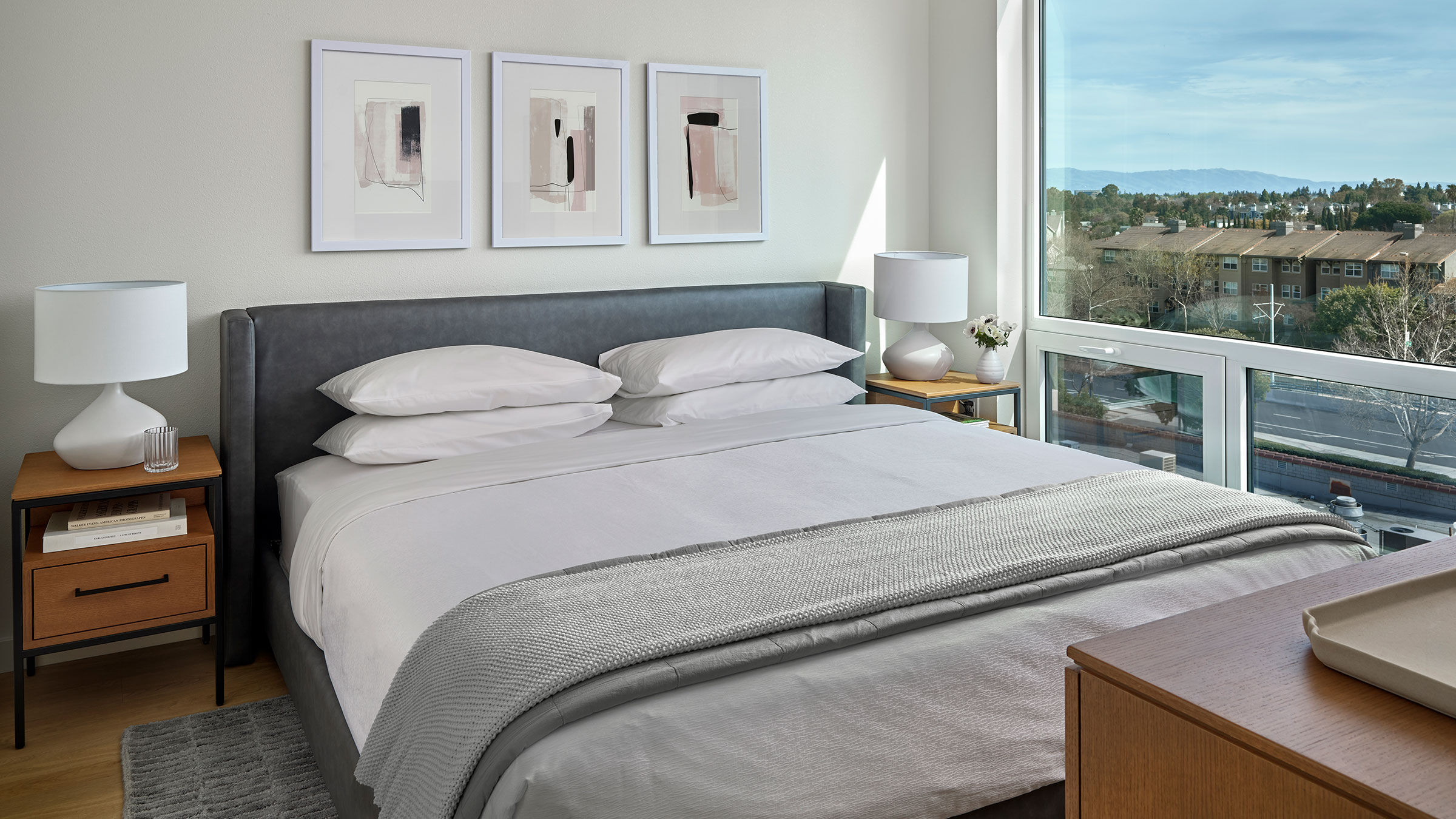 a bed with a headboard and a lamp