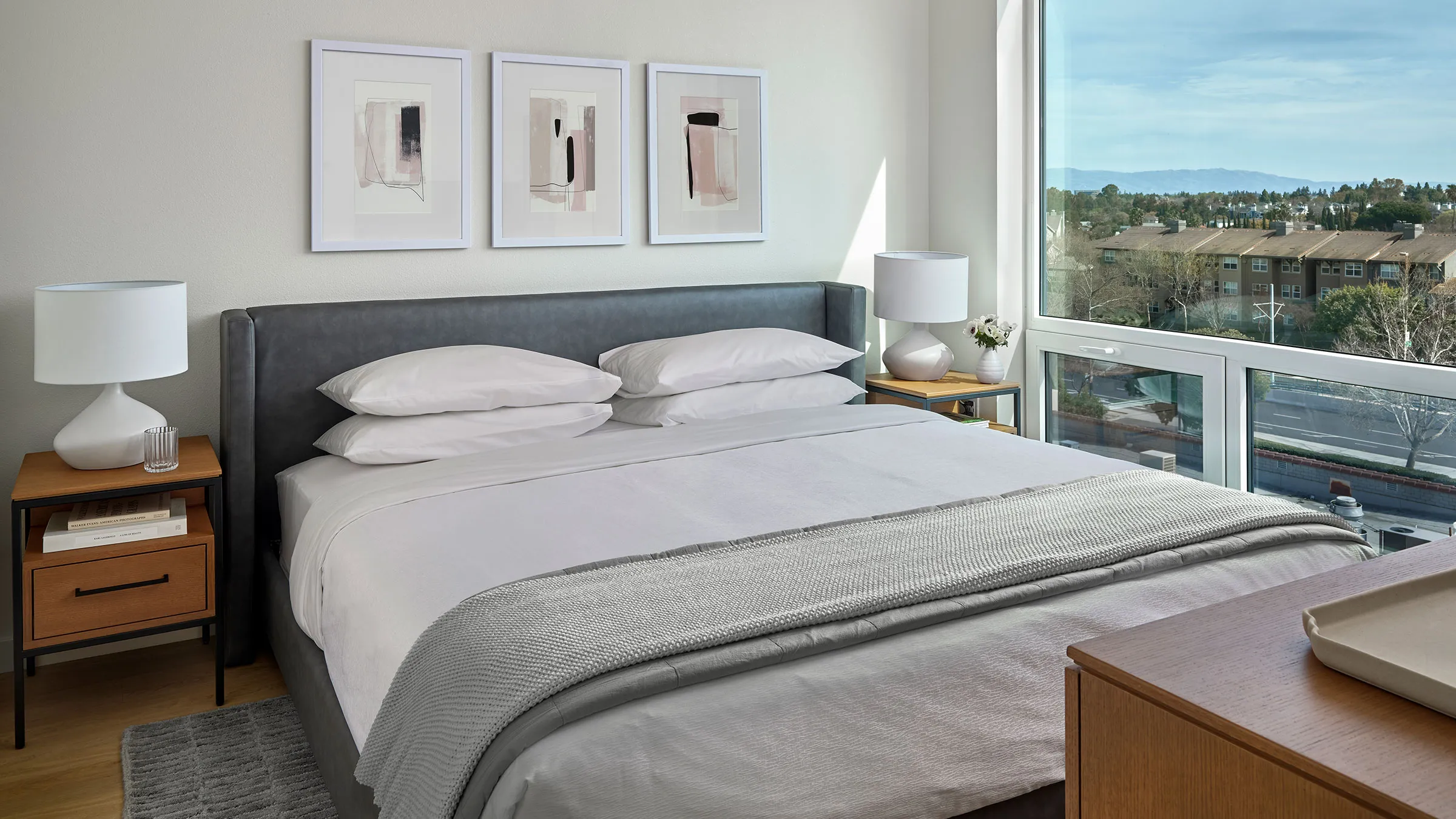 a bed with a headboard and a lamp