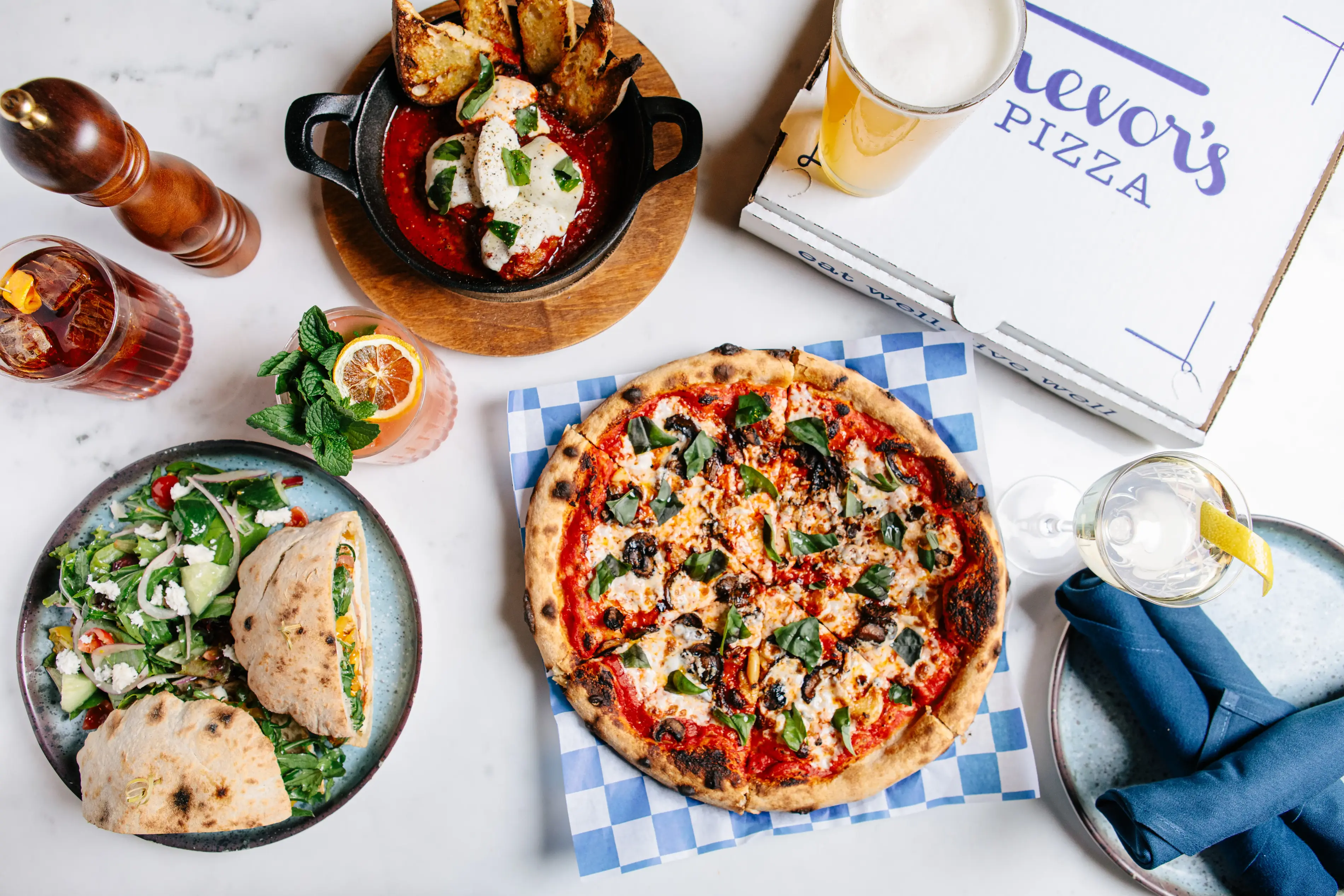 a pizza and a pizza box at Trevor's in Paradise Valley, AZ