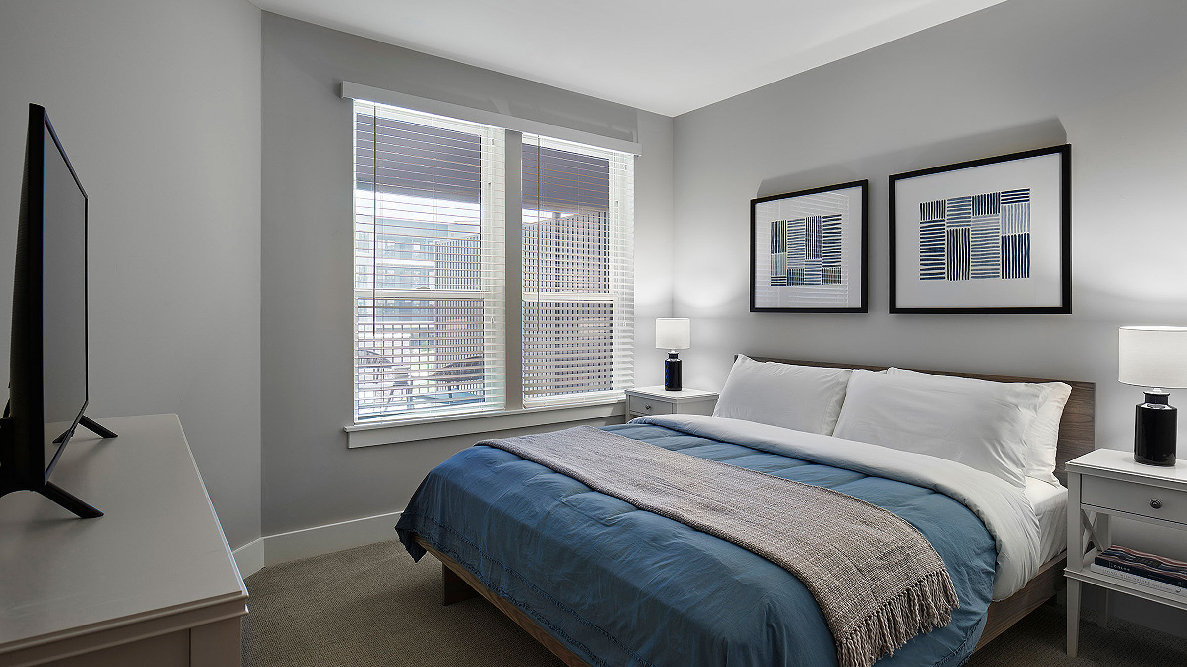 a bed with a lamp and a window