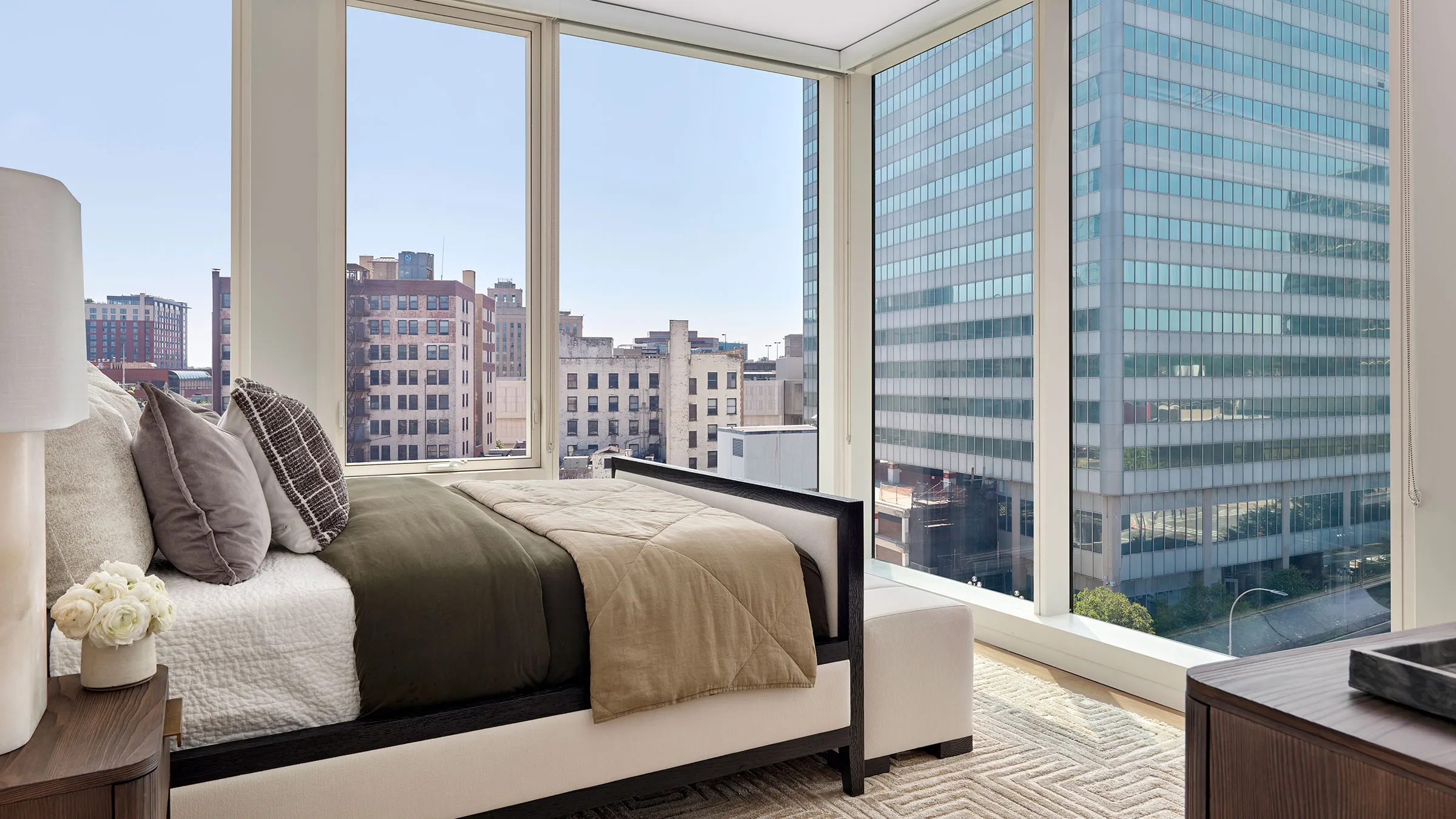 a bedroom with large windows and a bed