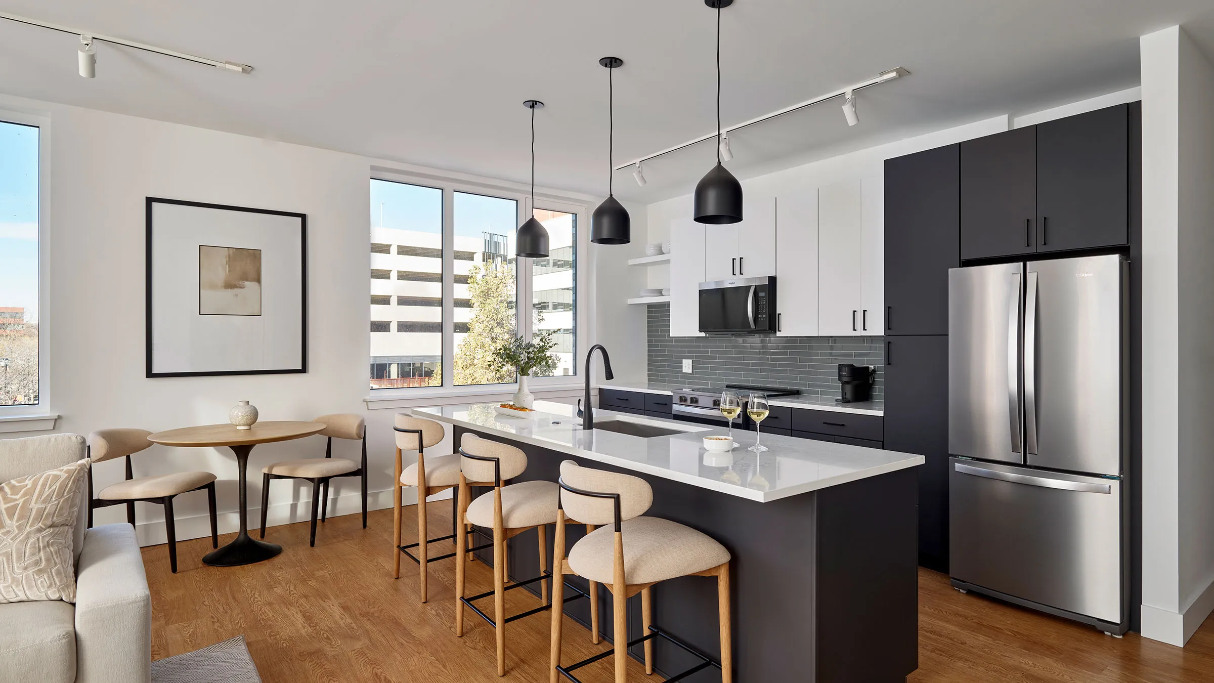 a kitchen with a bar and chairs