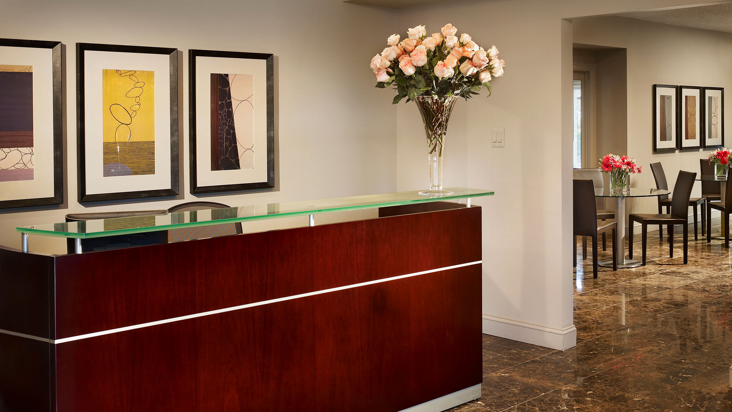a reception desk with flowers in a vase