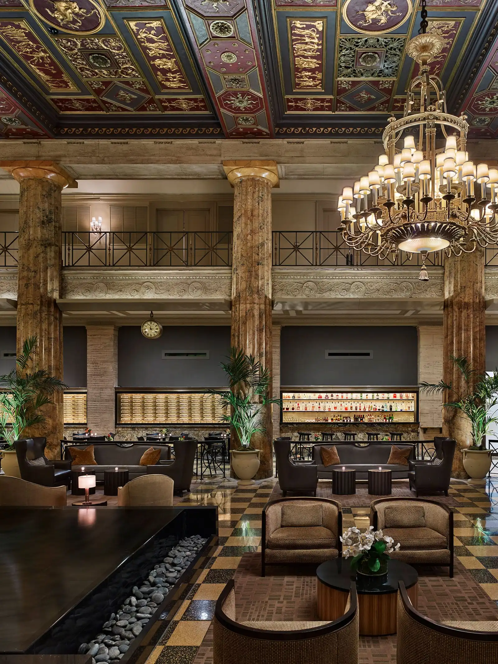 a large room with a chandelier and columns