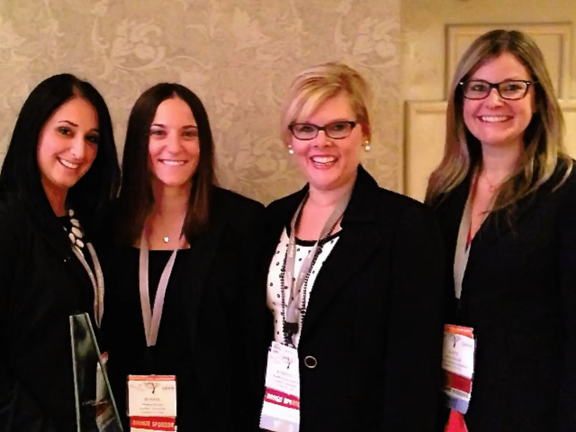 Women smiling at an award conference