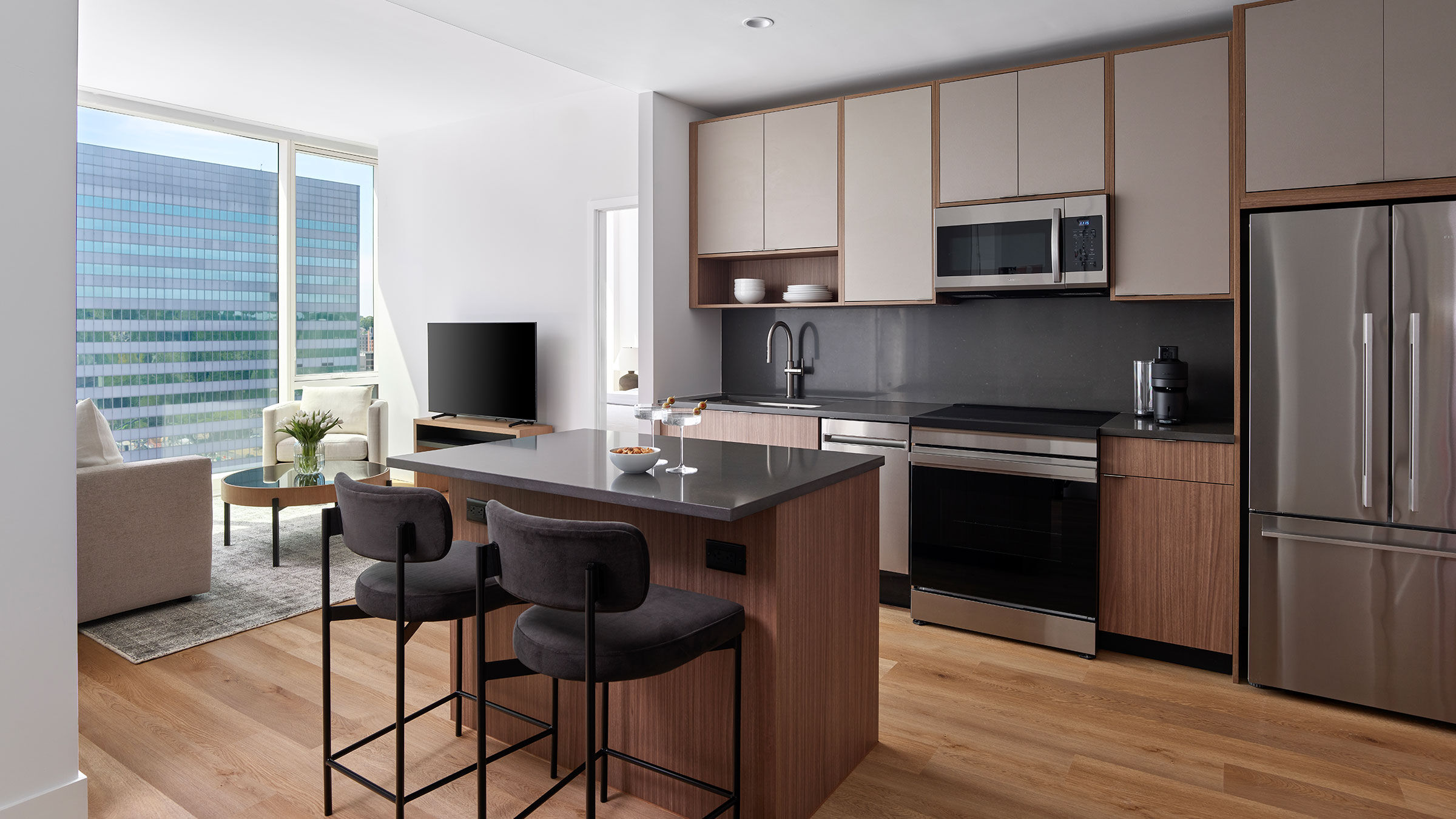 a kitchen with a bar and a television