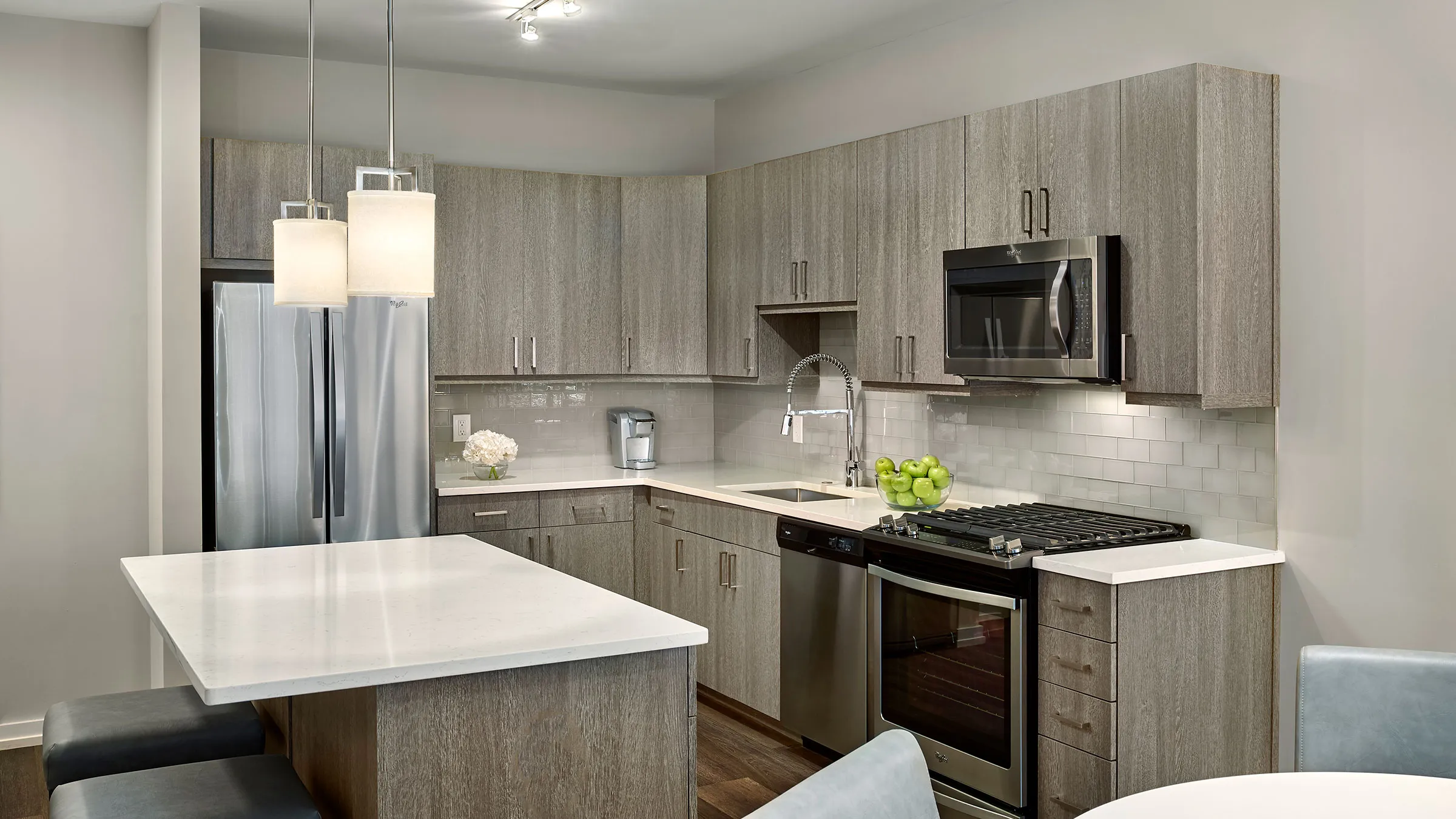a kitchen with a white counter top and a black stove