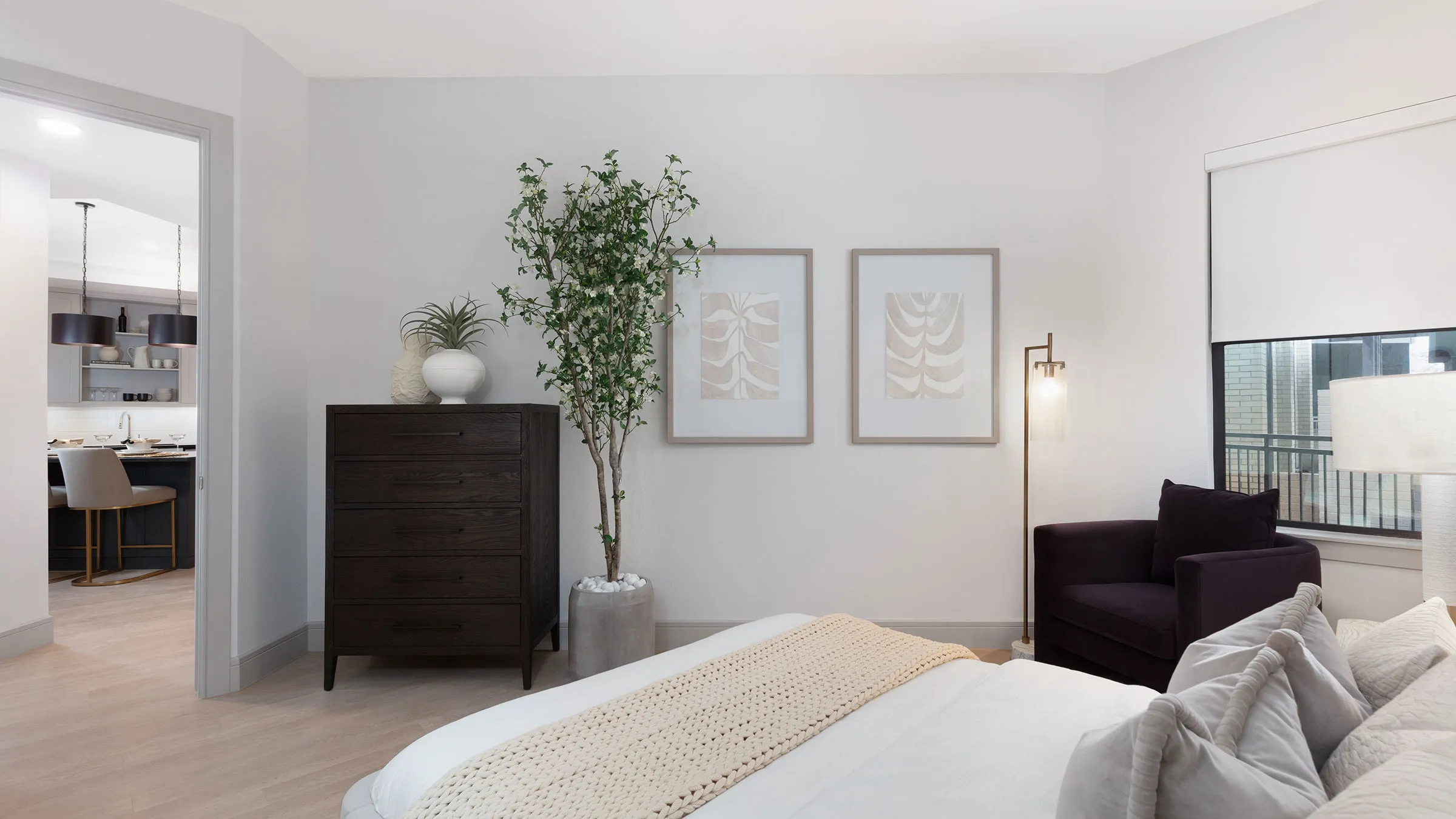 a room with a bed and a plant