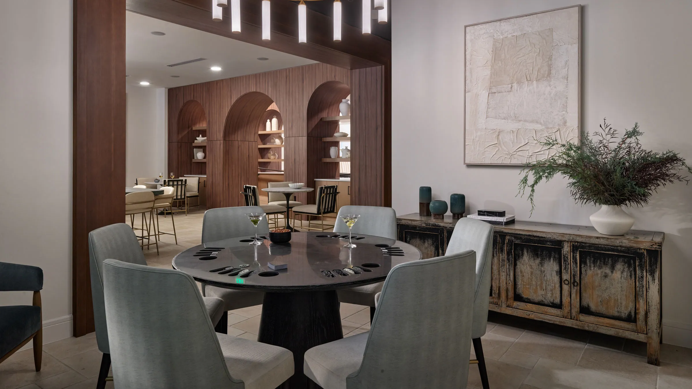 a room with a round table and chairs