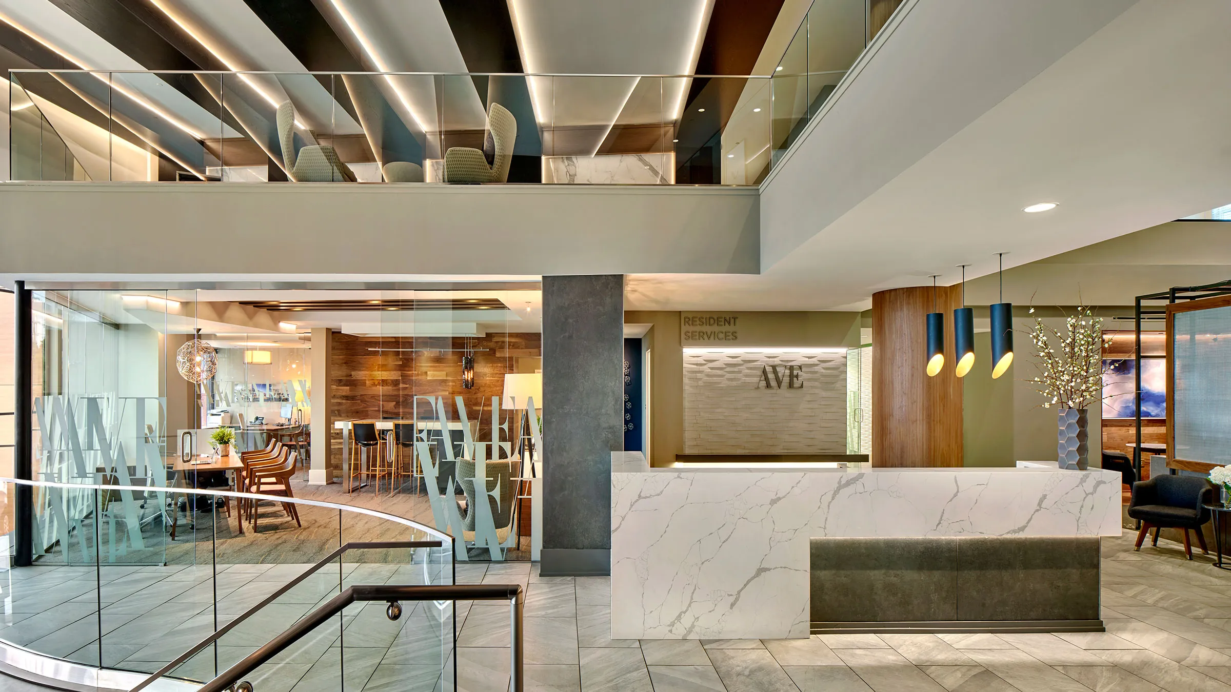 a lobby with a marble counter and a glass railing
