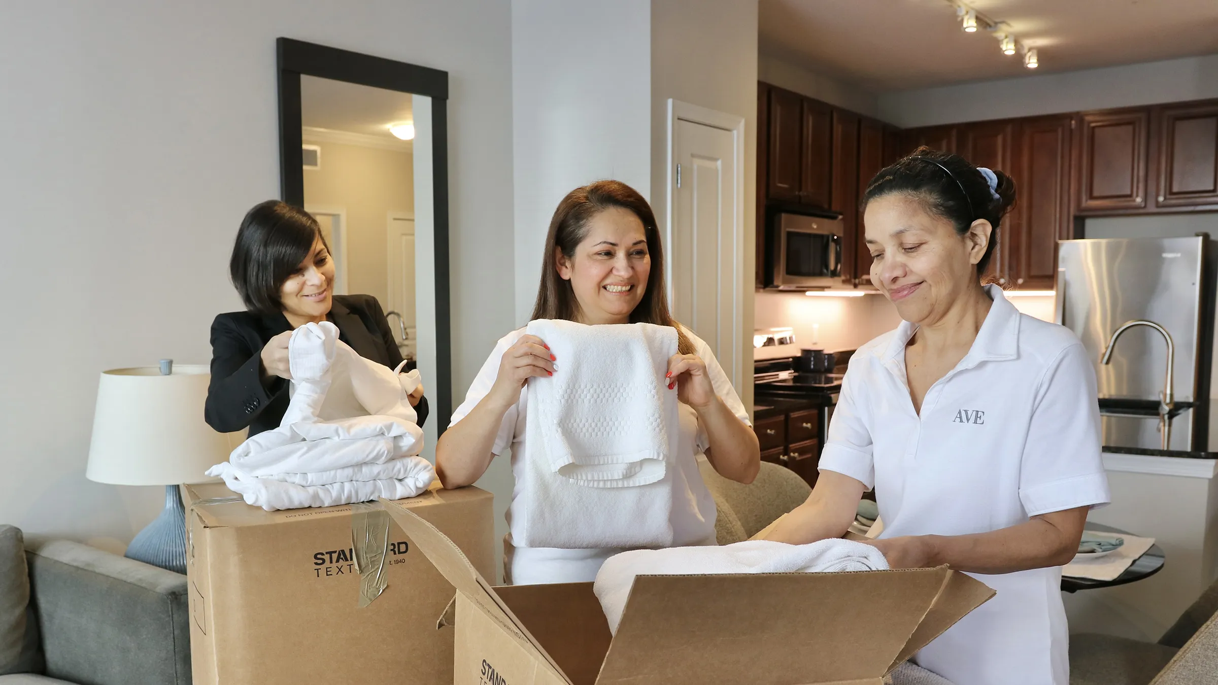 a group of AVE team members packing towels for standard textile