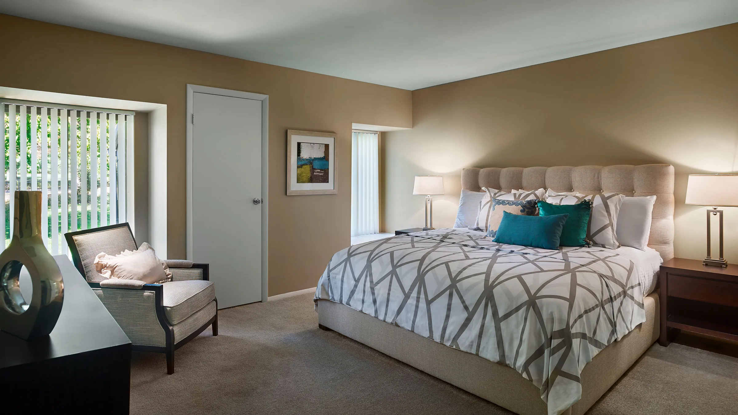 a bedroom with a bed and a chair