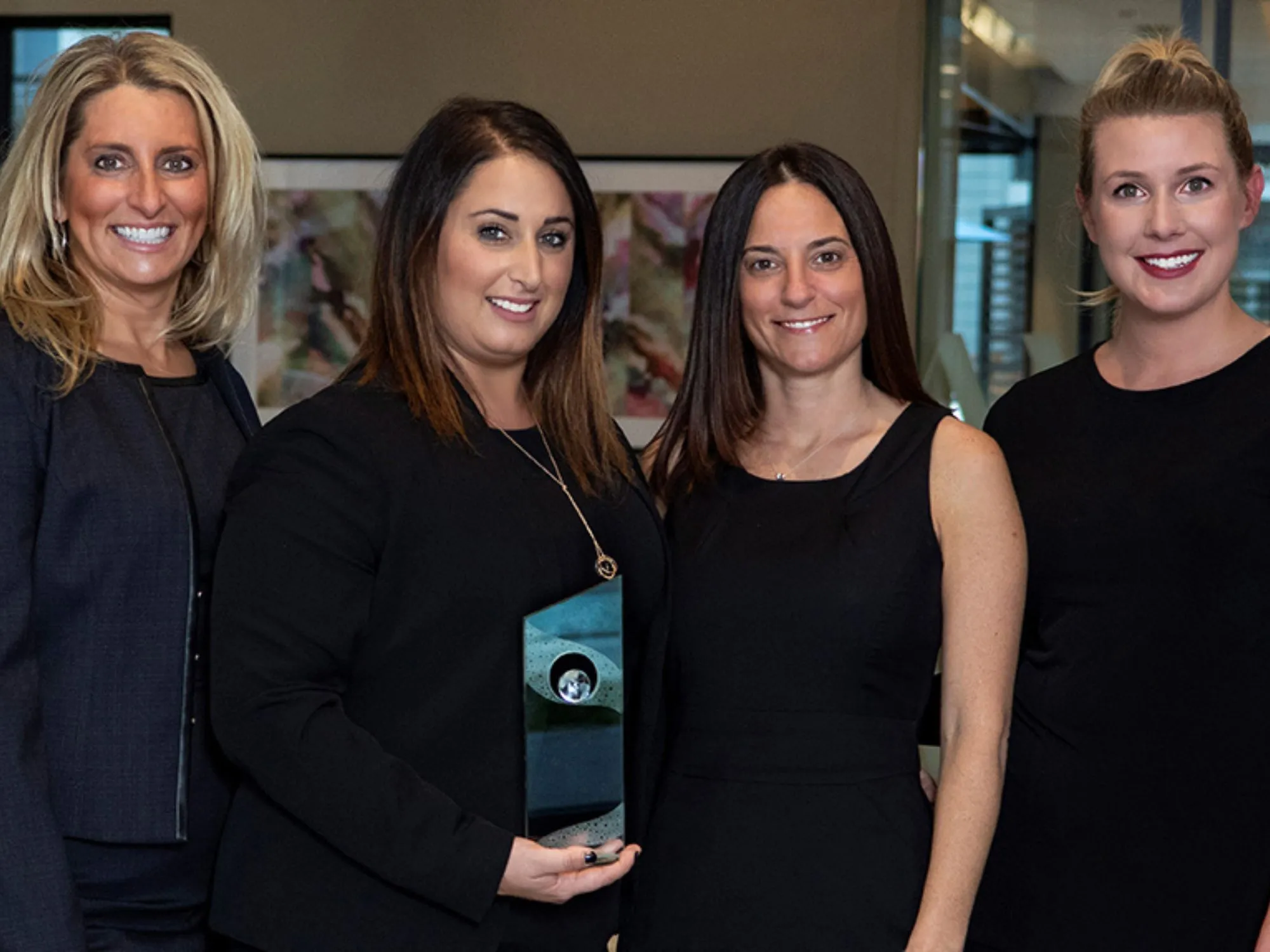 Four women holding an award