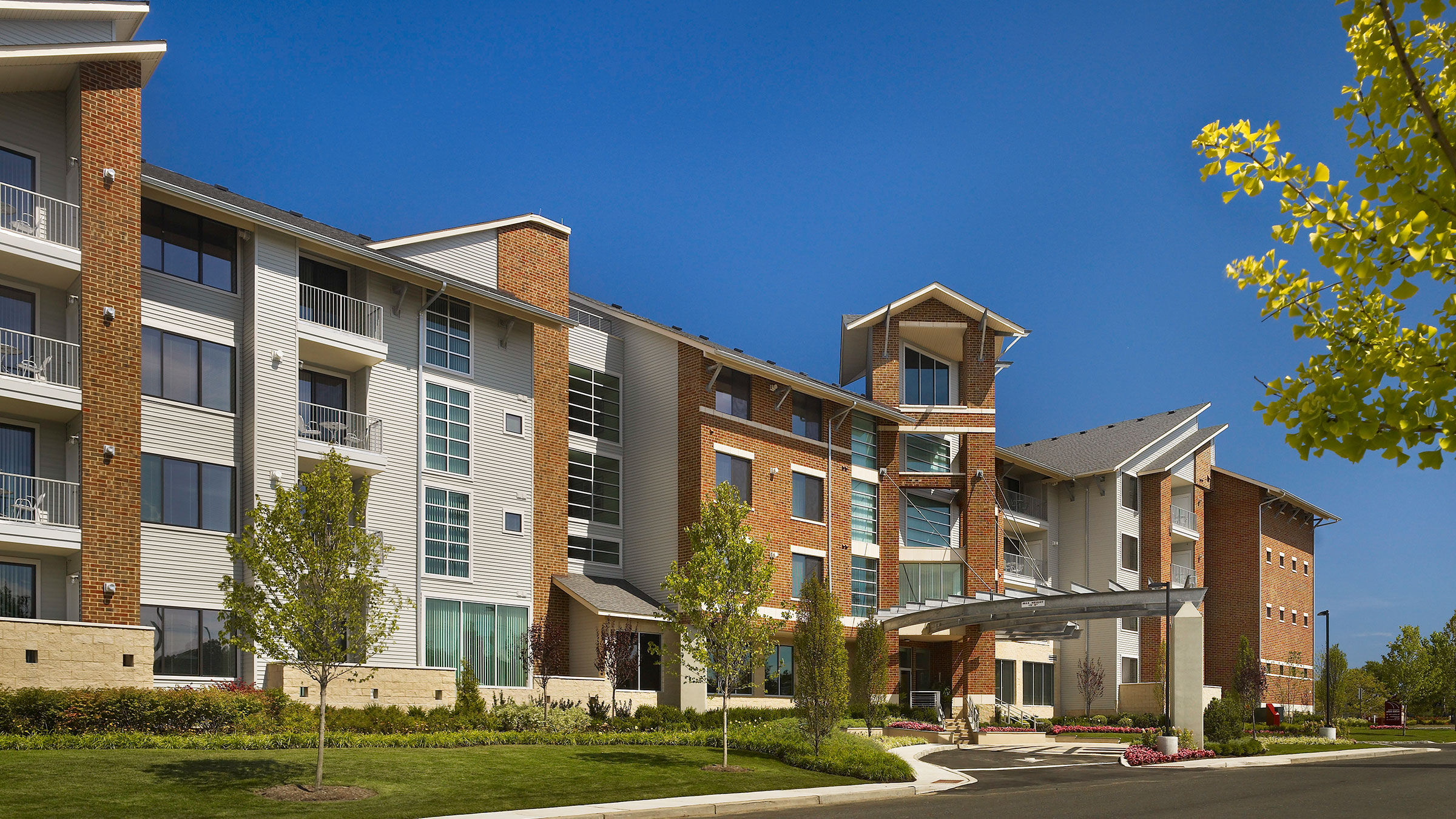 a building with a walkway and trees