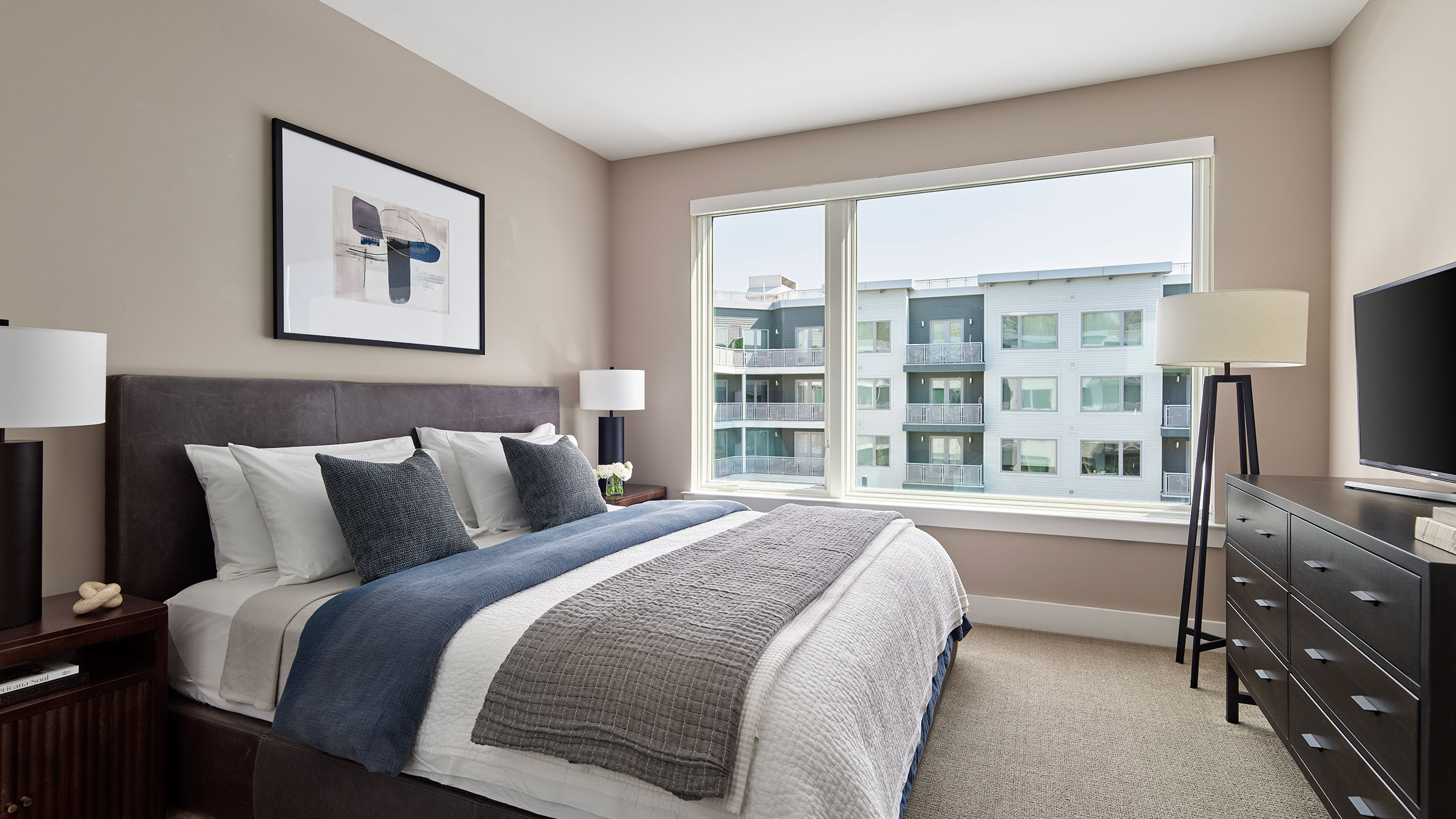 a bedroom with a large window