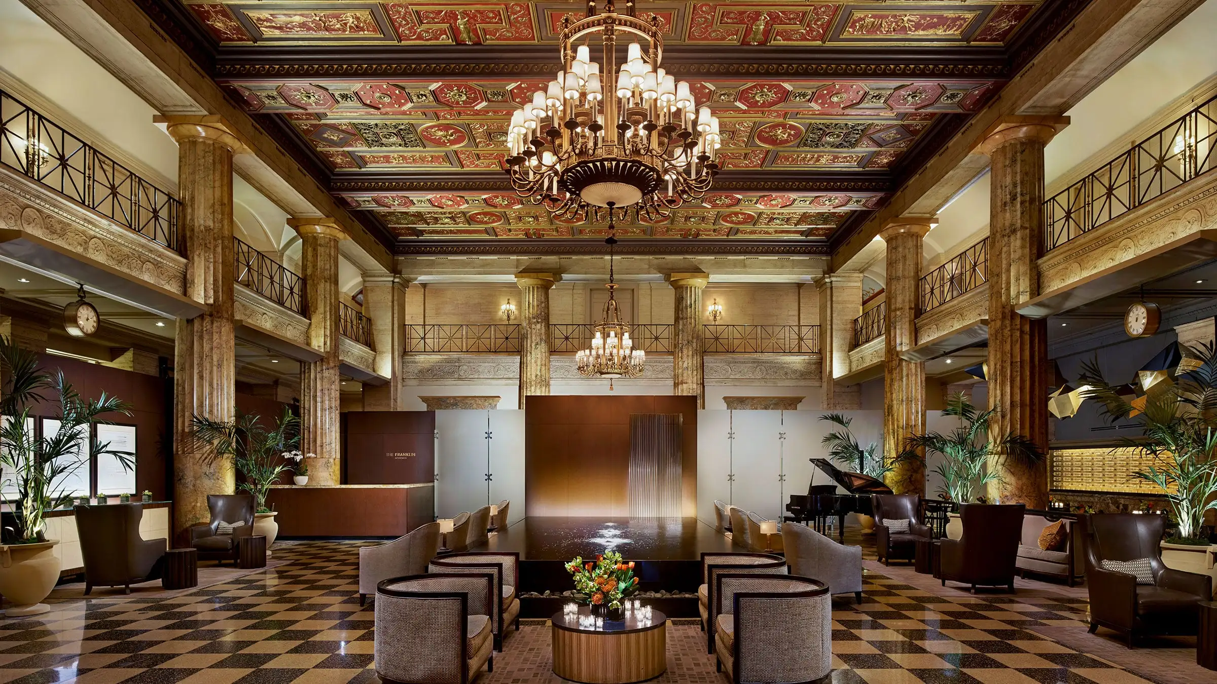 a room with a chandelier and a piano