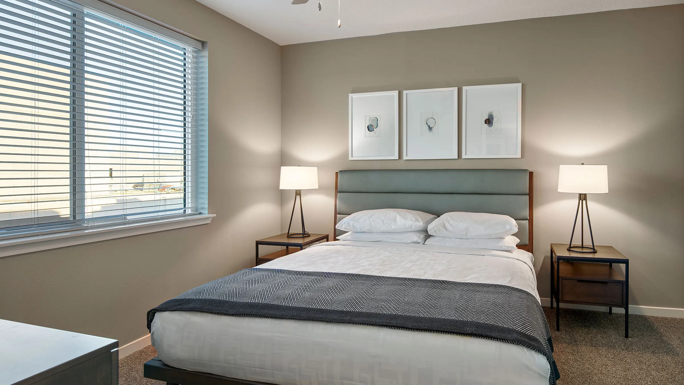 a bed with a lamp and a window