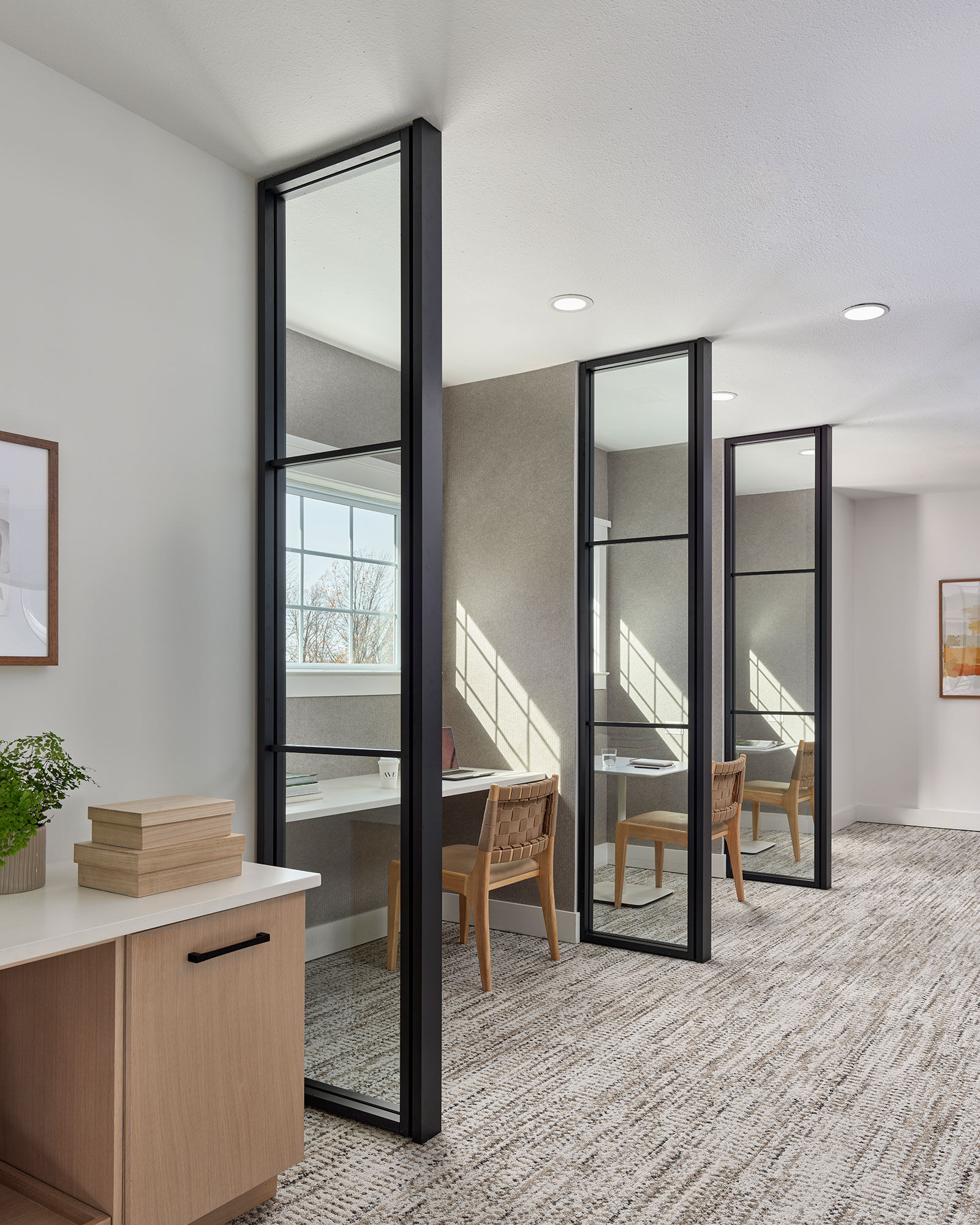 a room with glass walls and a desk