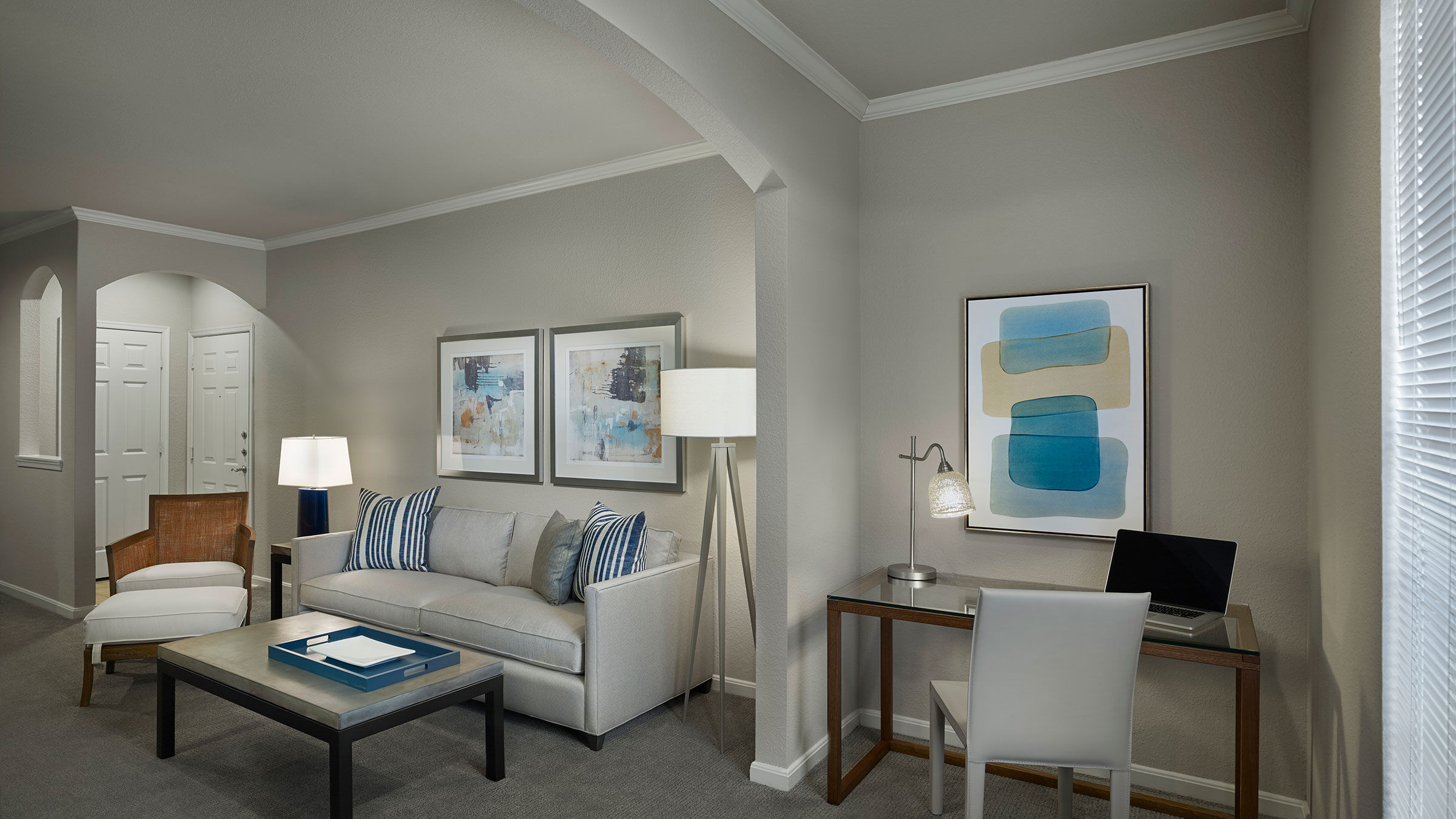 a living room with a couch and a desk