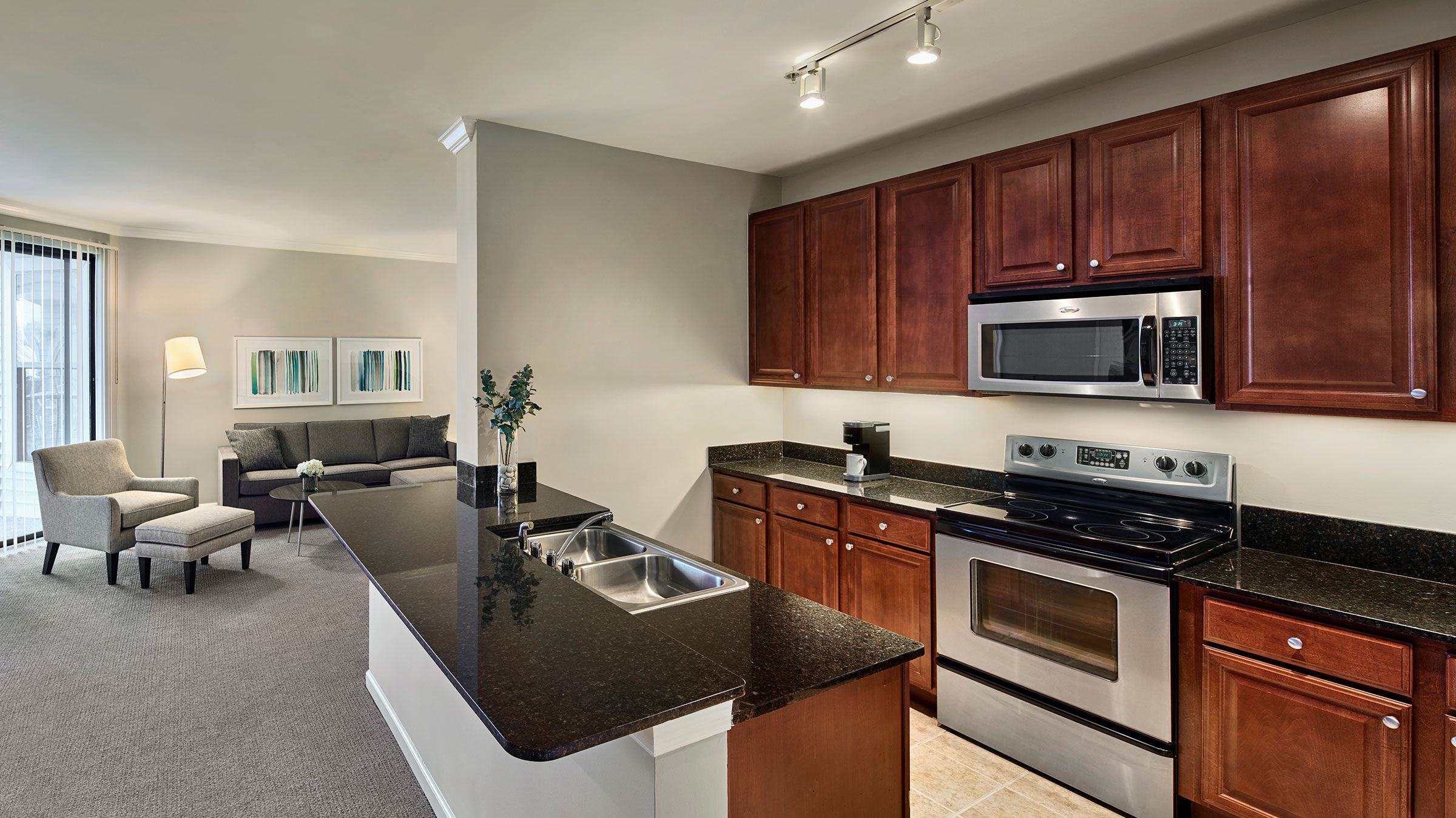 a kitchen with a black countertop and stainless steel appliances
